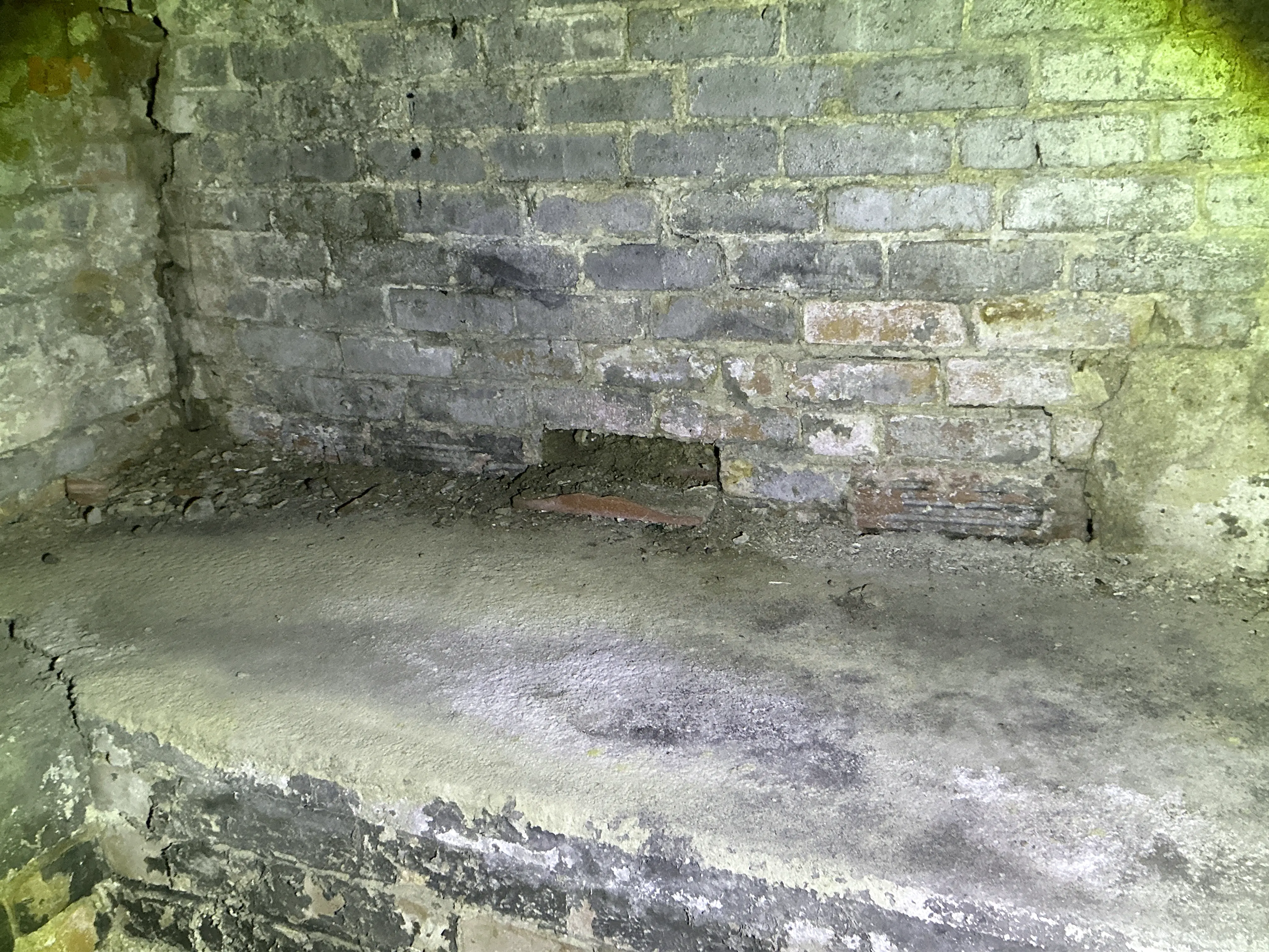Deteriorating brick masonry wall with missing bricks in crawlspace 2026-07-08