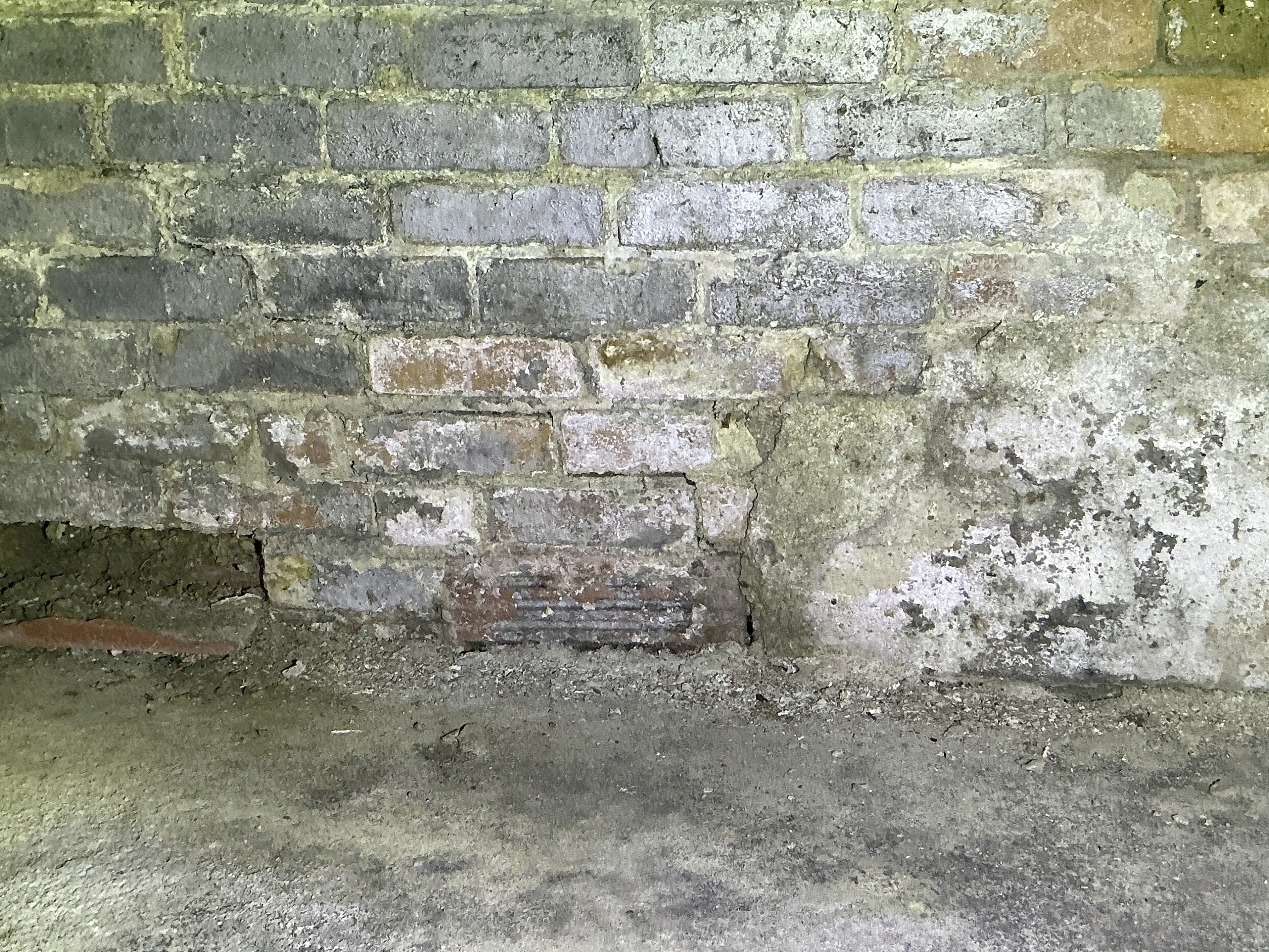 Brick foundation wall with mortar decay and moisture damage 2026-08-01