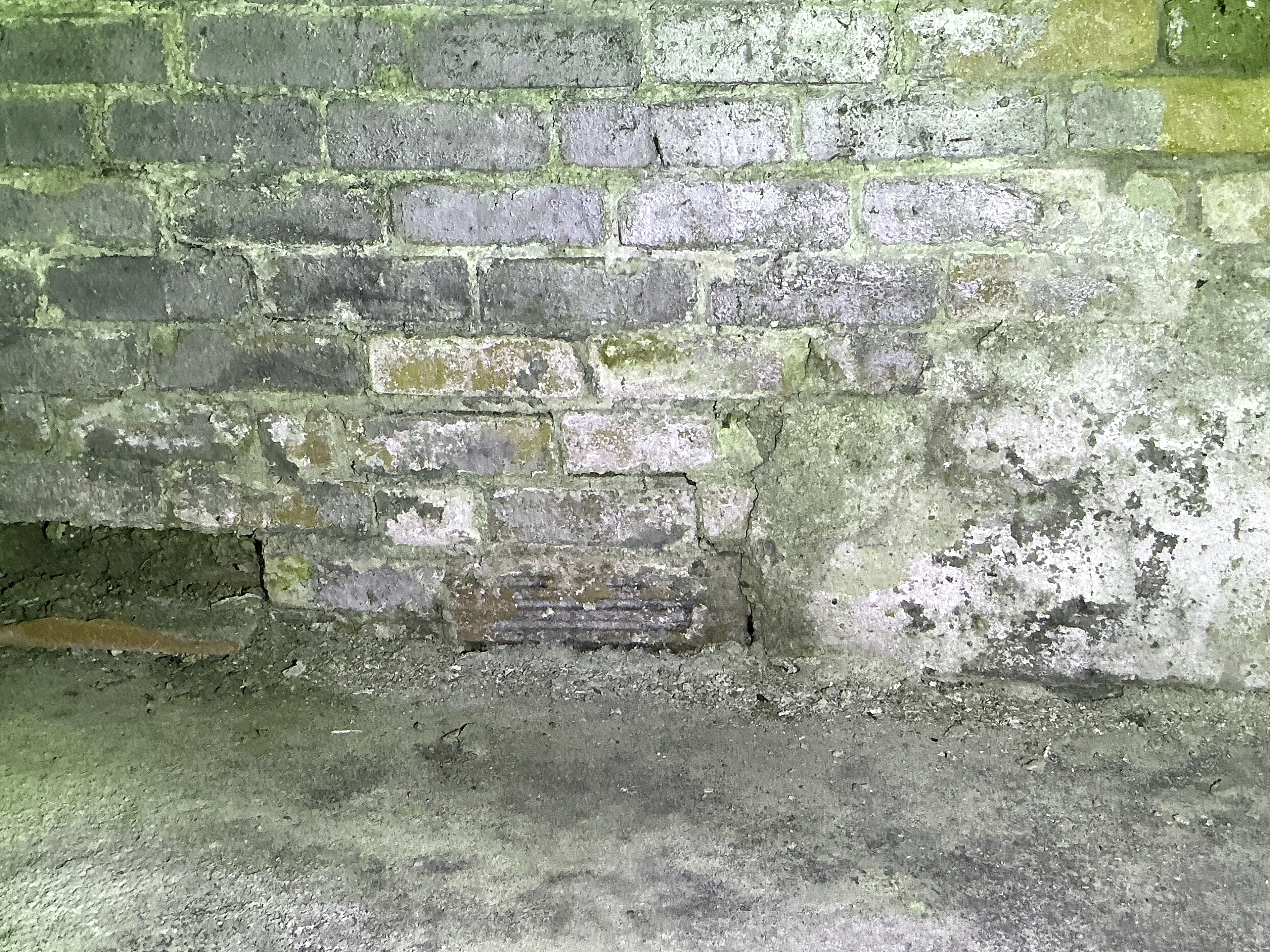 Brick foundation wall with mortar decay and moisture damage 2026-07-31