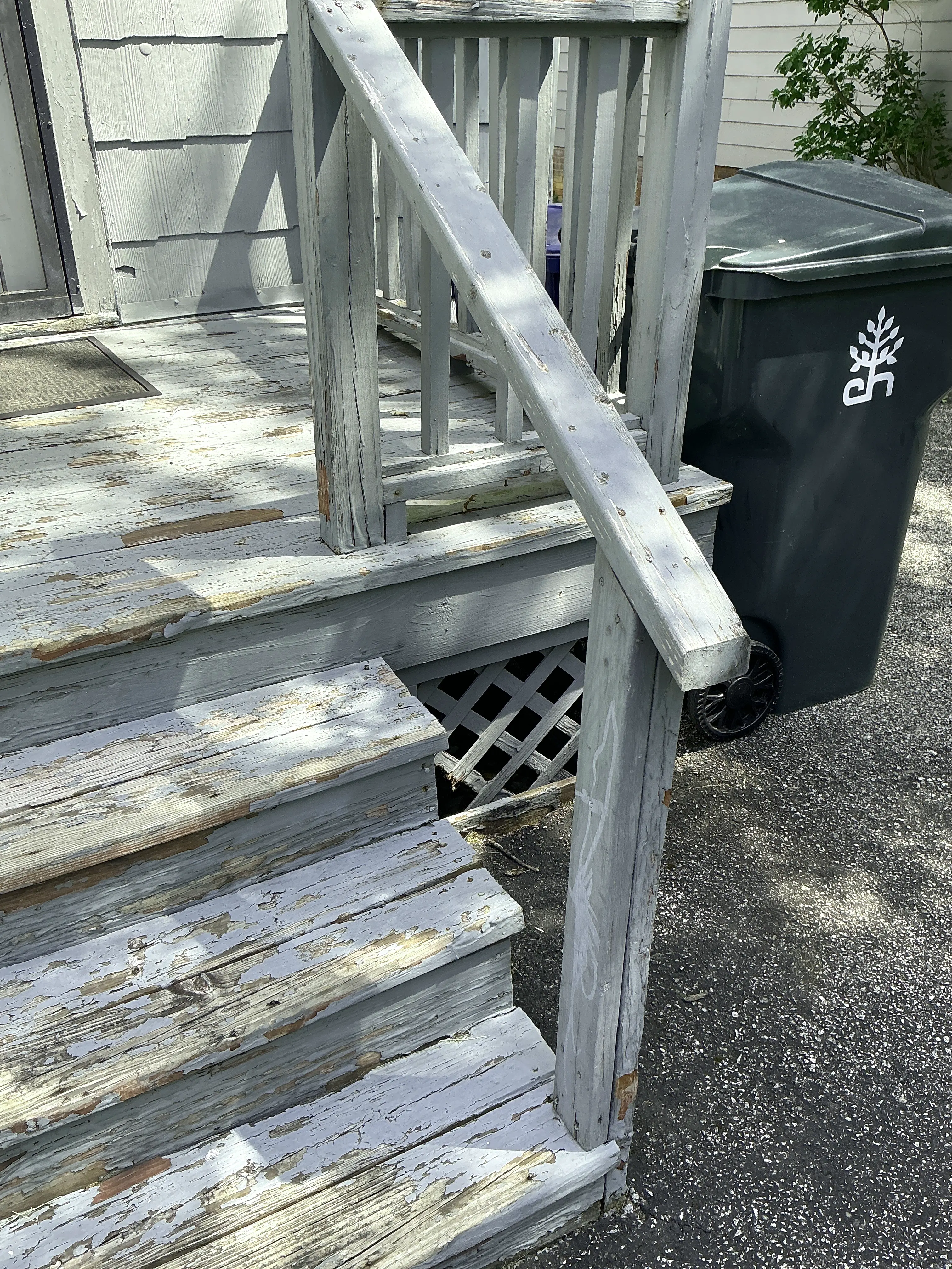 Peeling paint and weathered wood on exterior porch stairs during indoor air quality testing 2026-08-04