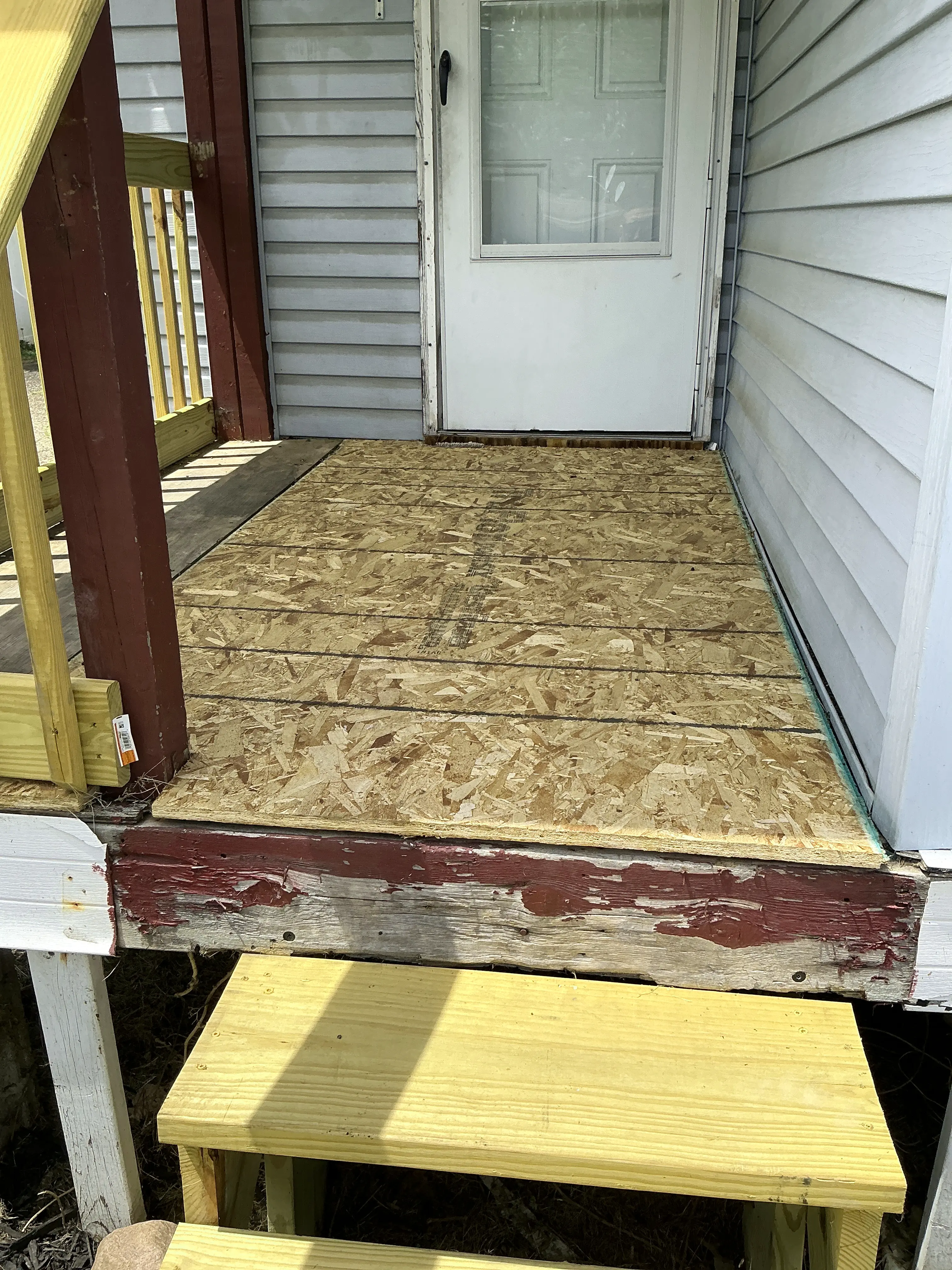 Unfinished OSB subfloor decking on exterior porch during mold inspection 2026-08-31