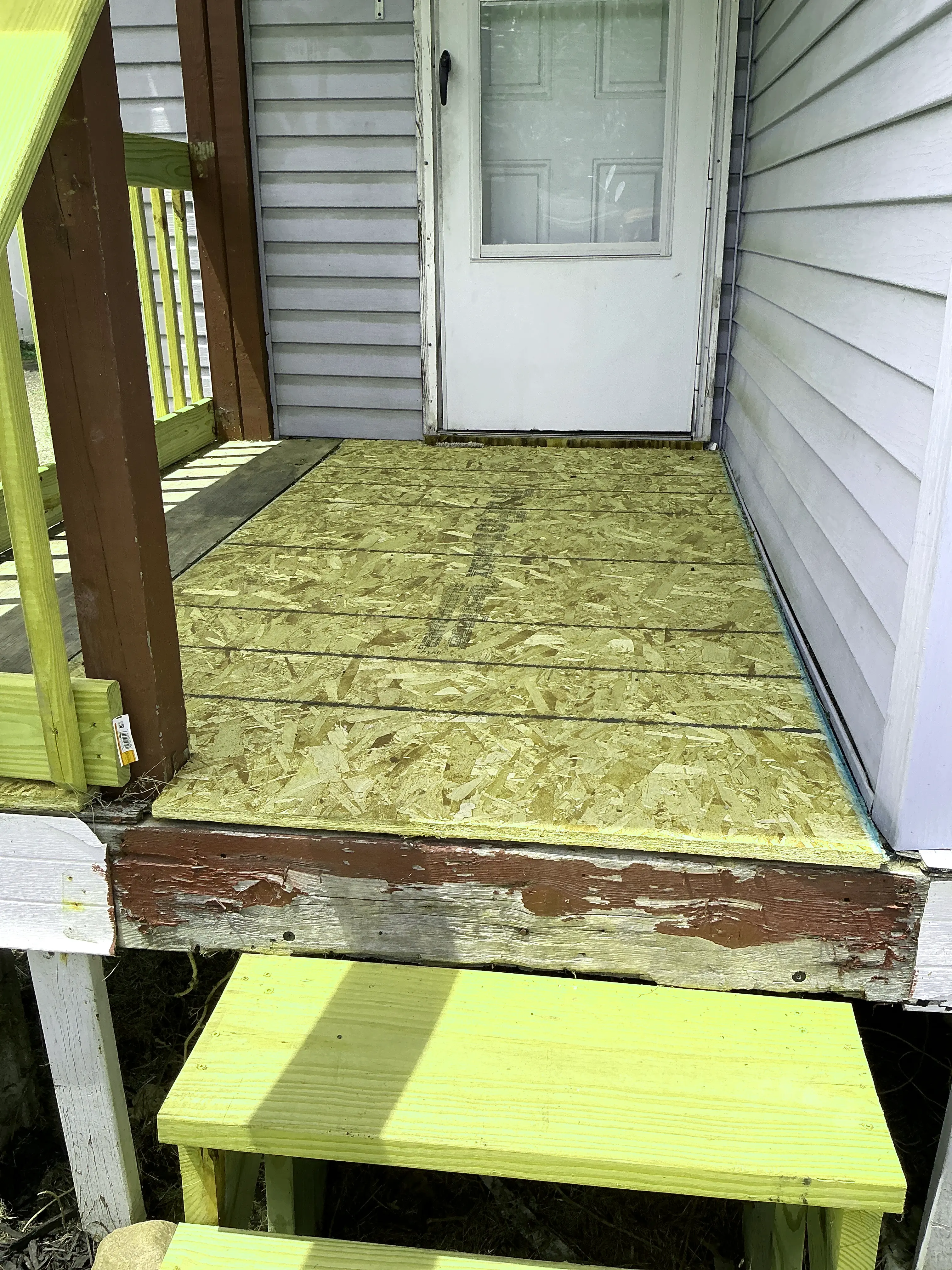 Unfinished OSB subfloor decking on exterior porch during indoor air quality testing 2026-07-24
