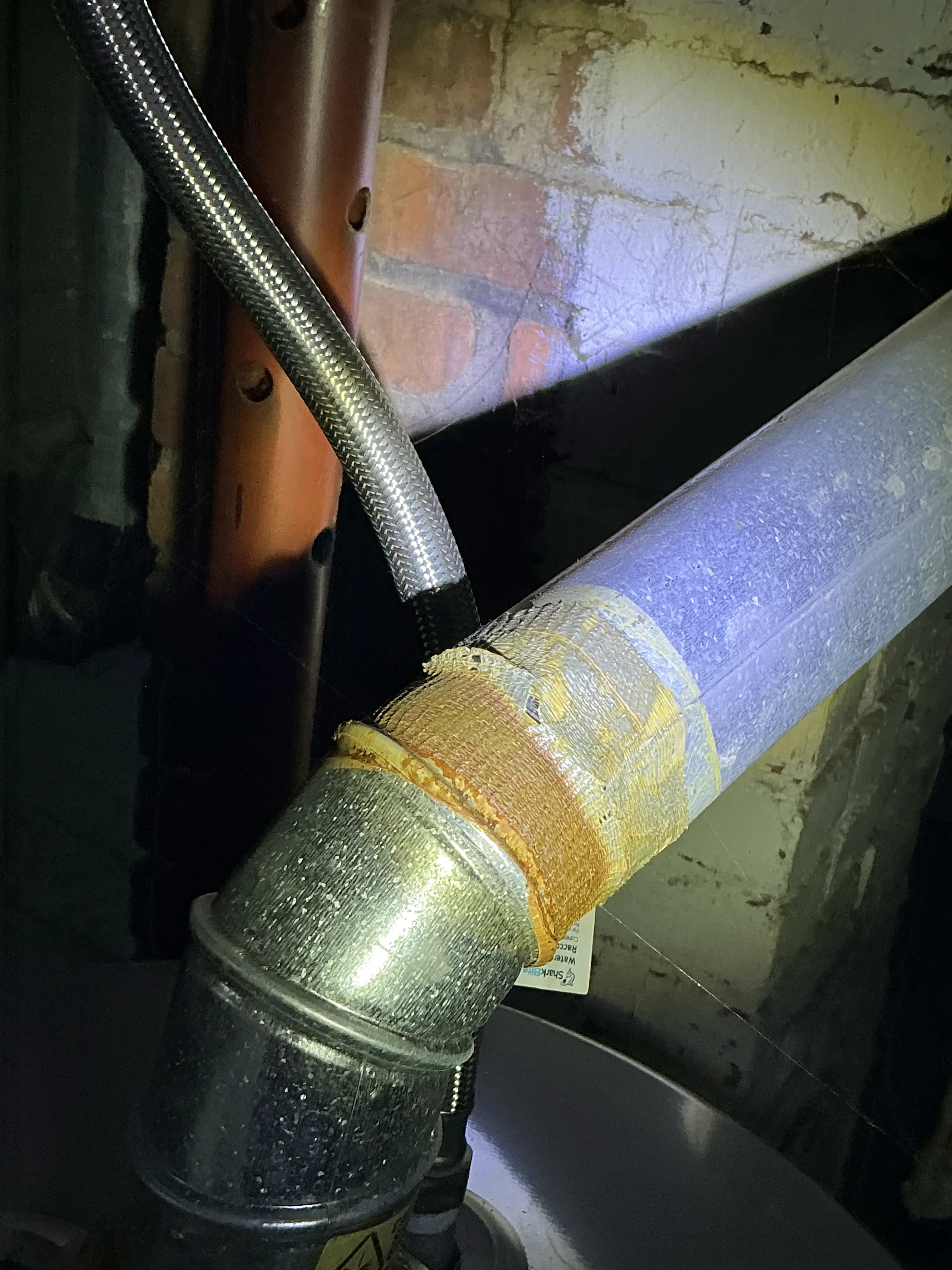 Deteriorated tape repair on metal exhaust vent pipe joint 2026-07-12