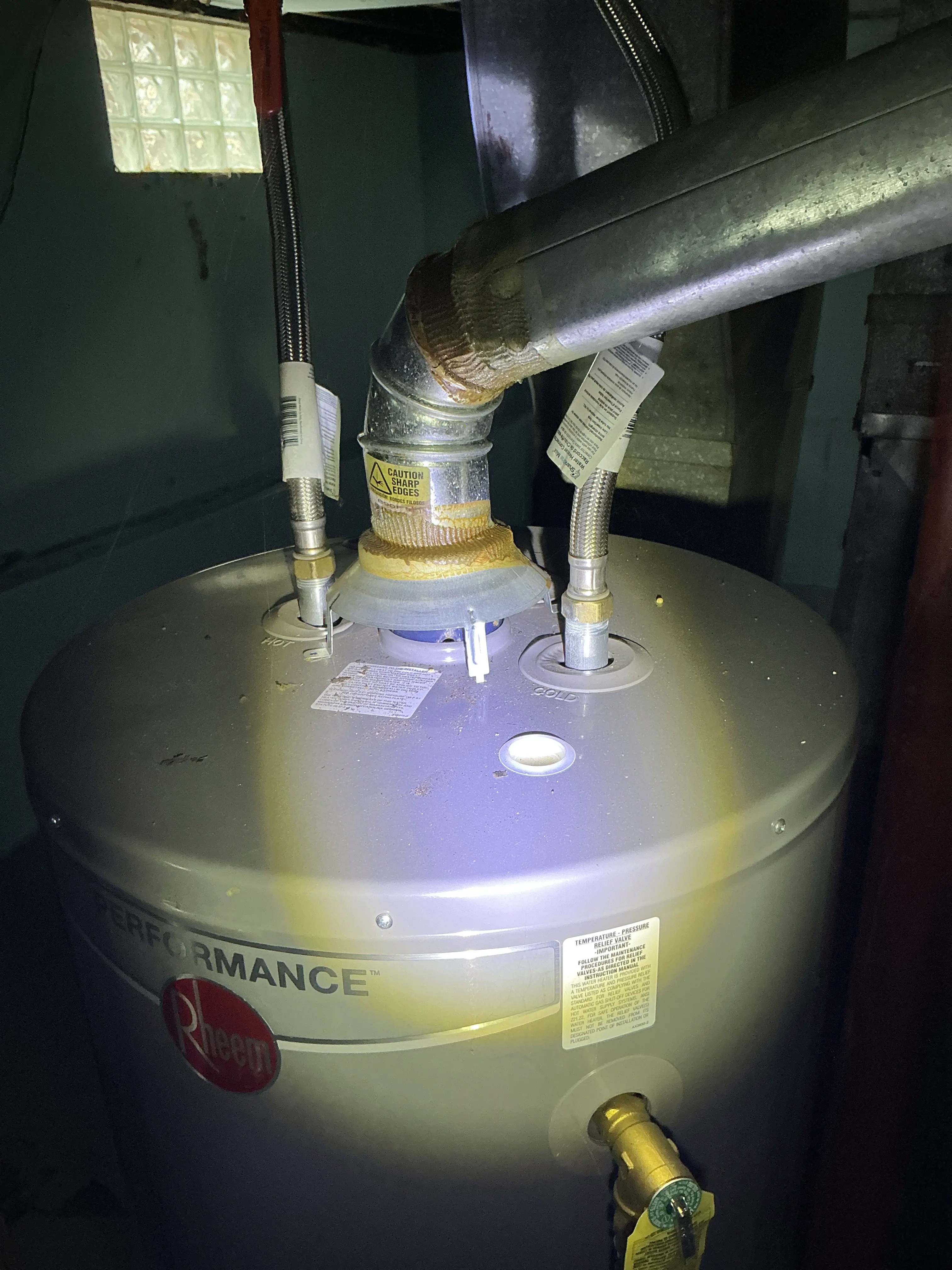 Rheem gas water heater top connections with flexible supply pipes and draft diverter flue pipe 2026-07-22