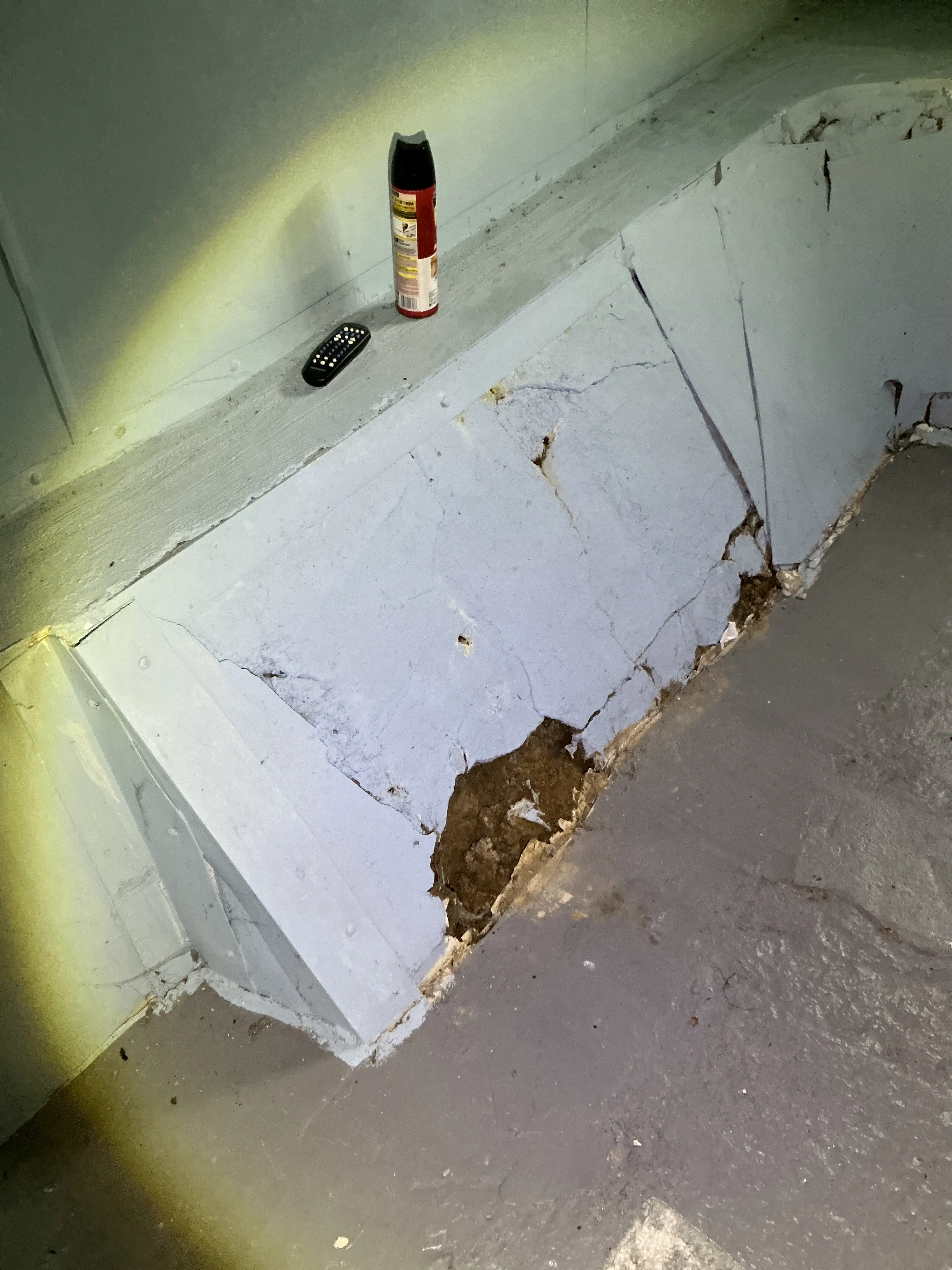 Cracked and damaged plaster ceiling with exposed structural hole illuminated by flashlight 2026-08-26