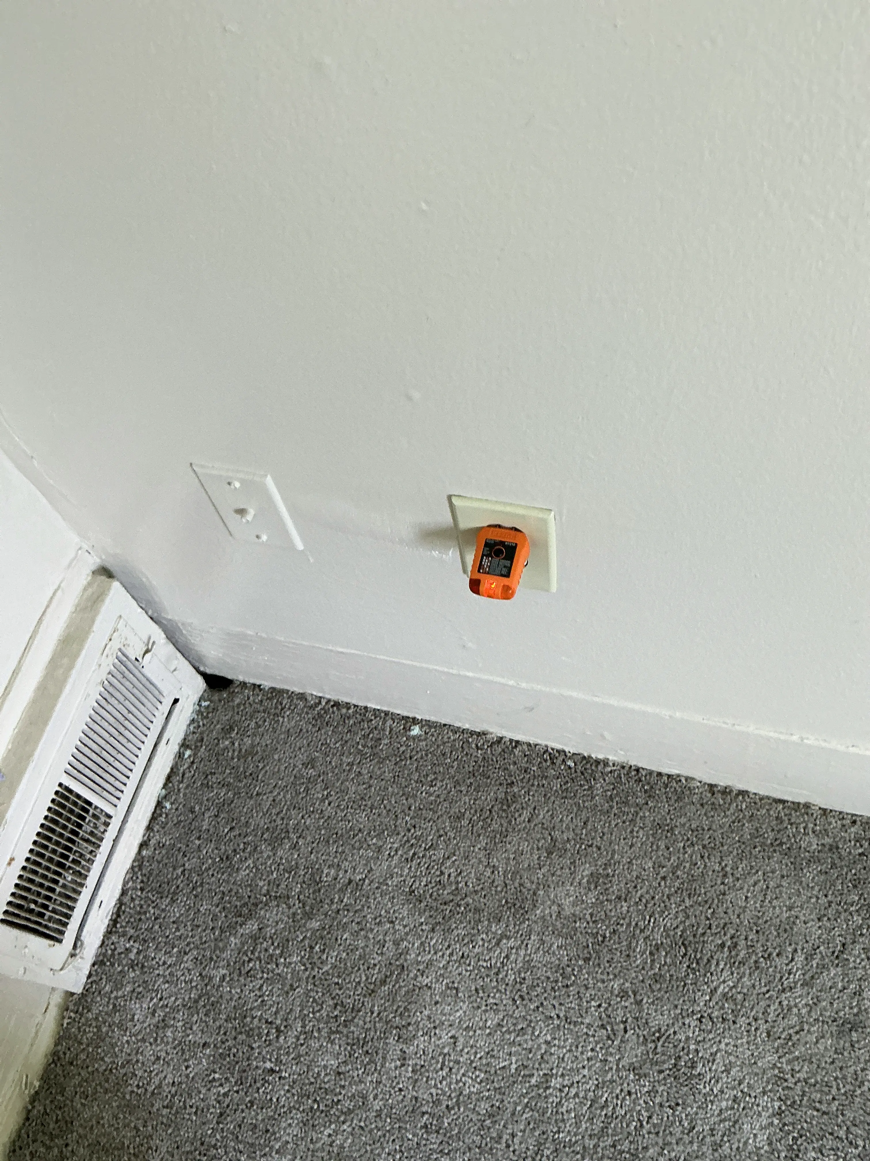 Receptacle tester plugged into a wall outlet during a home electrical inspection 2026-08-28