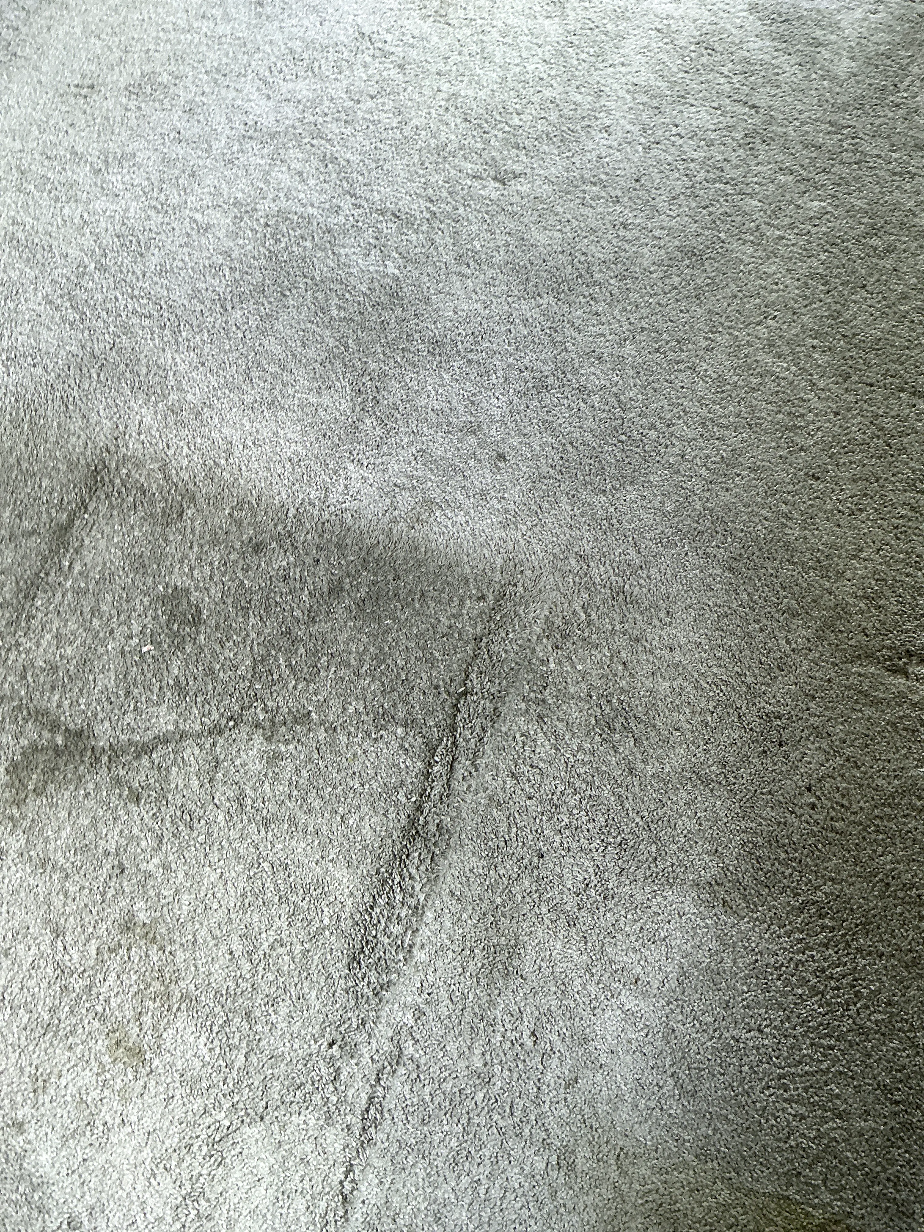 Close-up of grey carpet fabric texture during general inspection 2026-07-23