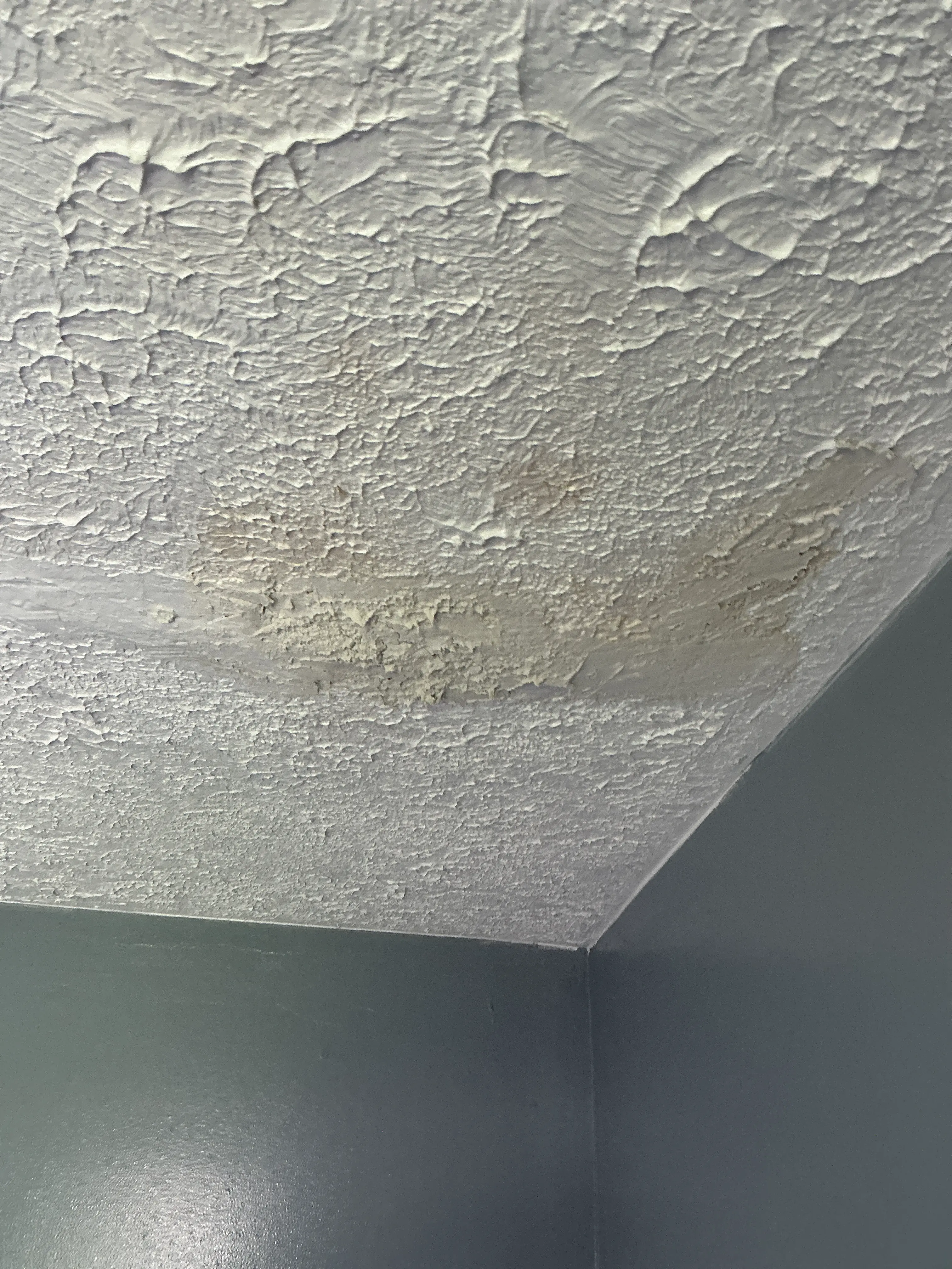 Water stain and damaged texture on interior wall corner during a mold testing 2026-07-07
