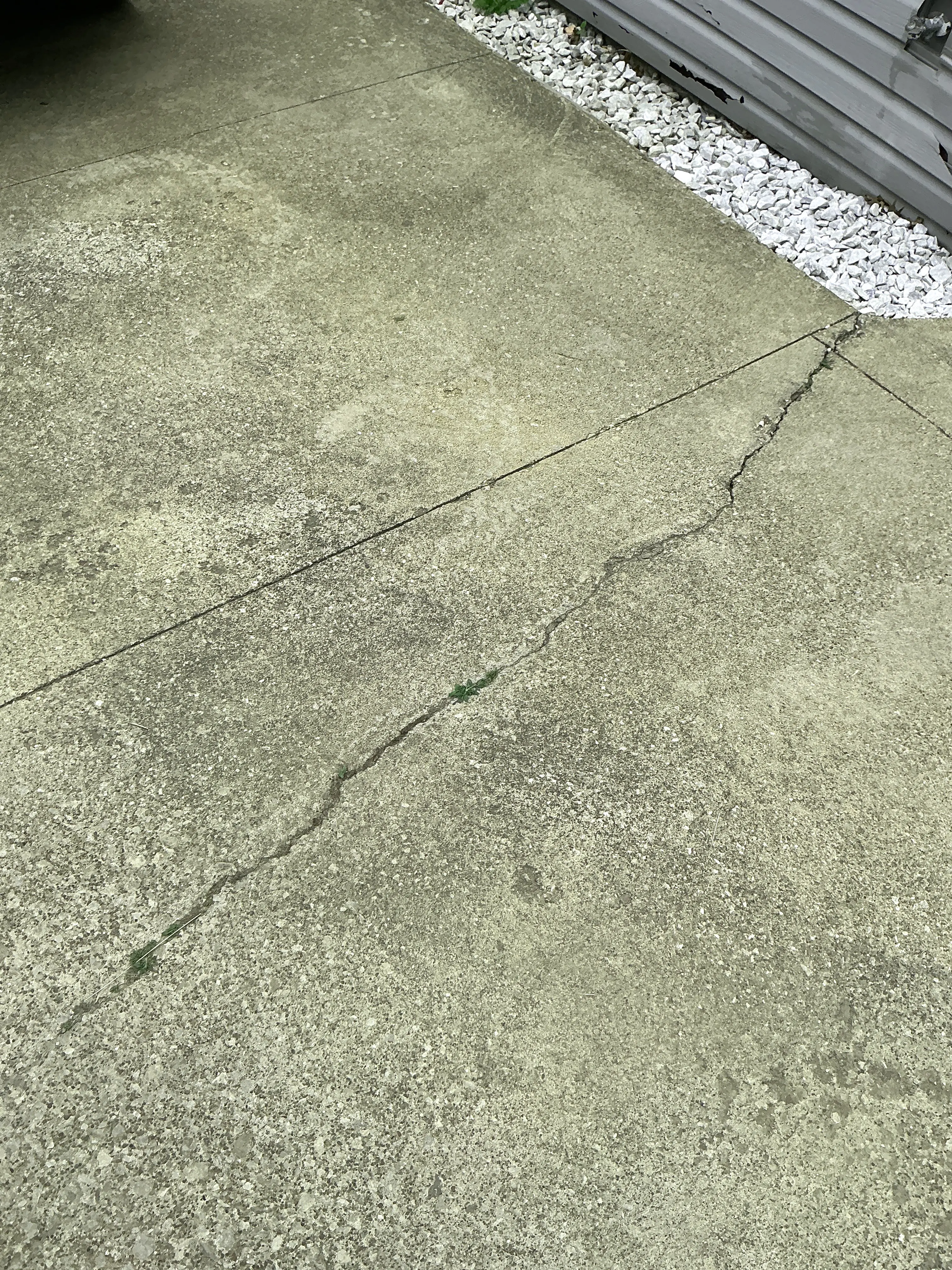Cracked concrete driveway slab requiring maintenance during general inspection 2026-08-31
