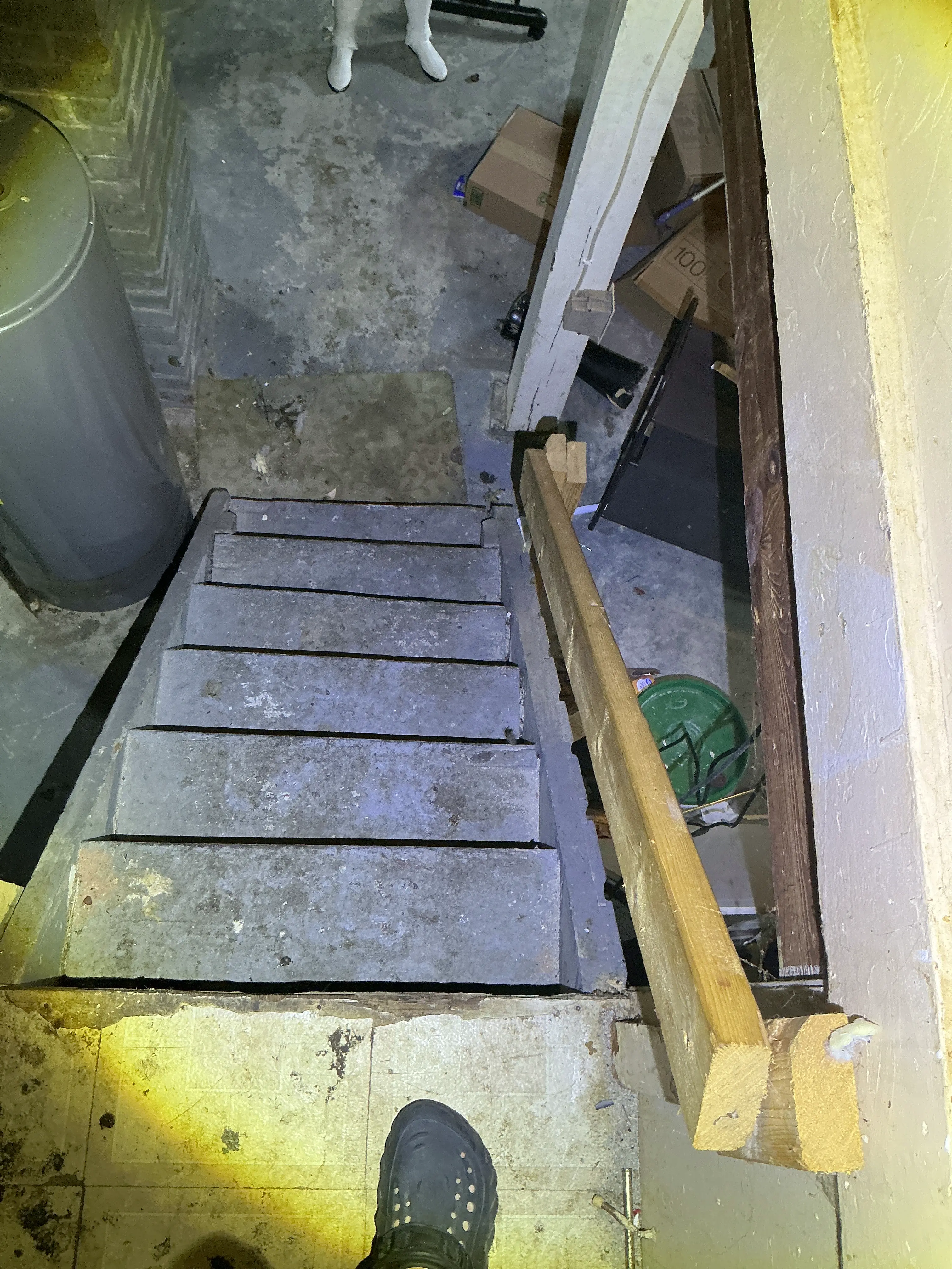 Unsafe wooden basement stairs with a temporary handrail seen during a home inspection. 2026-07-20