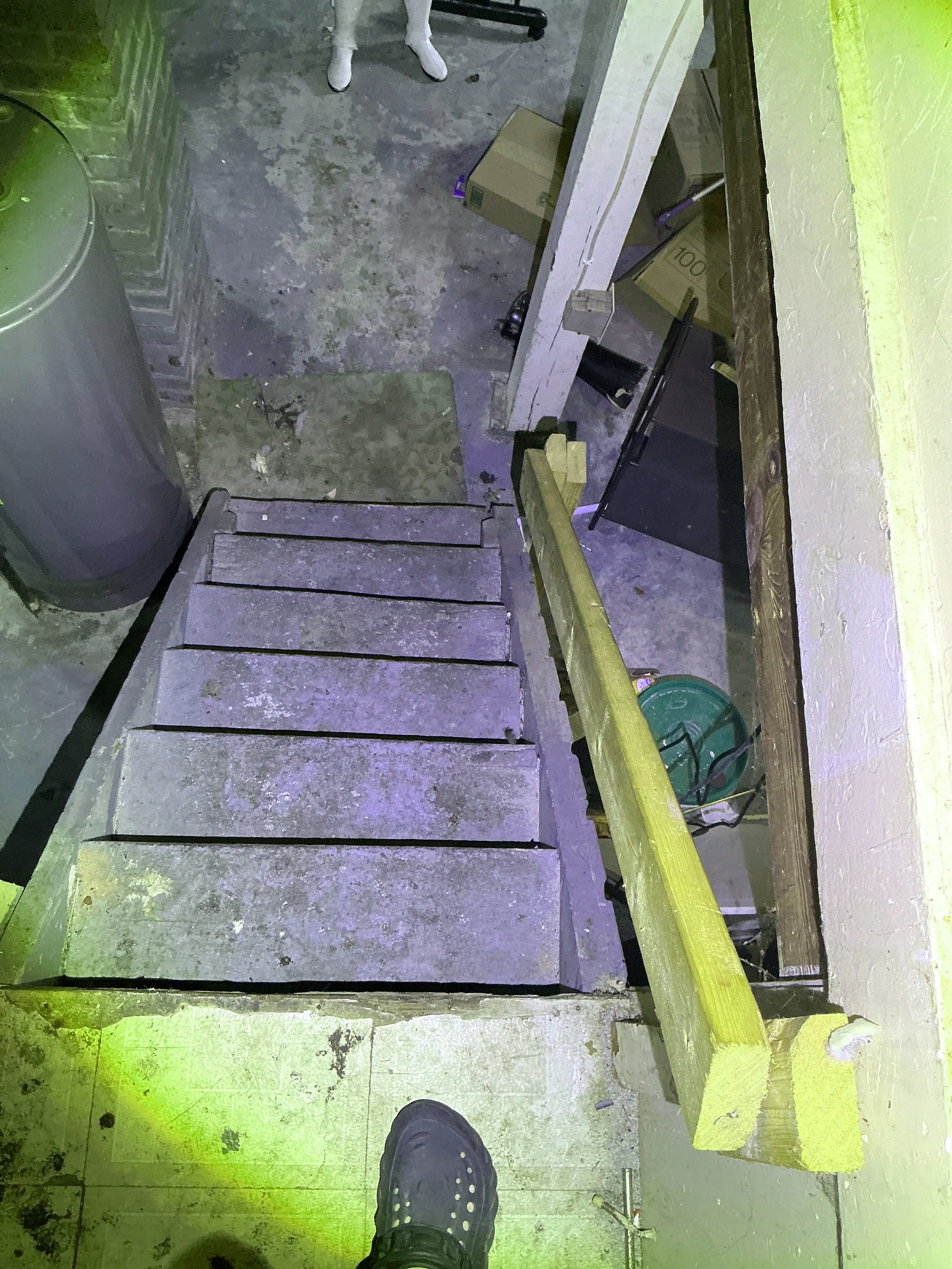 Unsafe wooden basement stairs with a temporary handrail seen during a home inspection. 2026-07-08