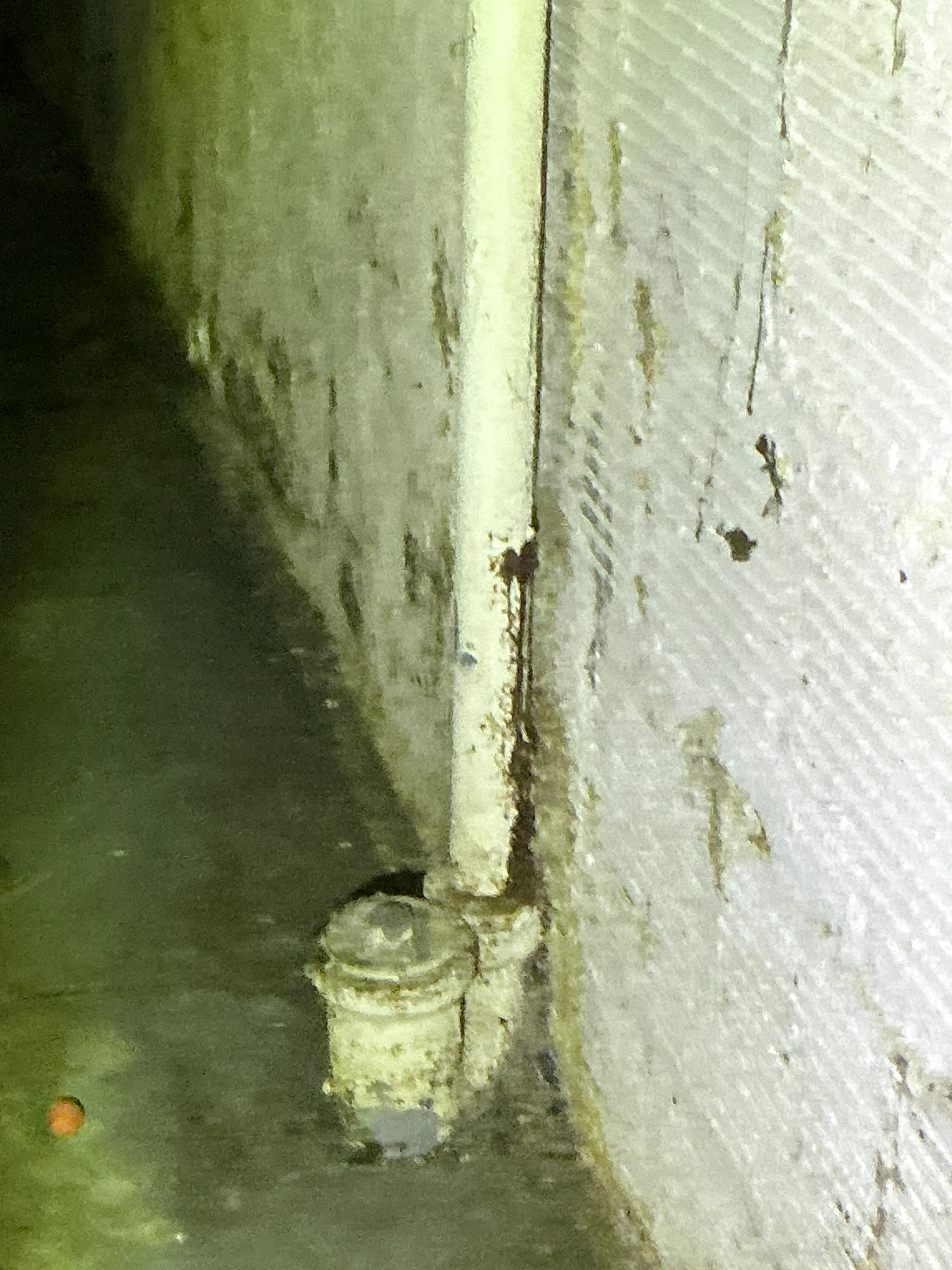 Corroded pipe conduit and connector fitting under structure during lead inspection 2026-08-16