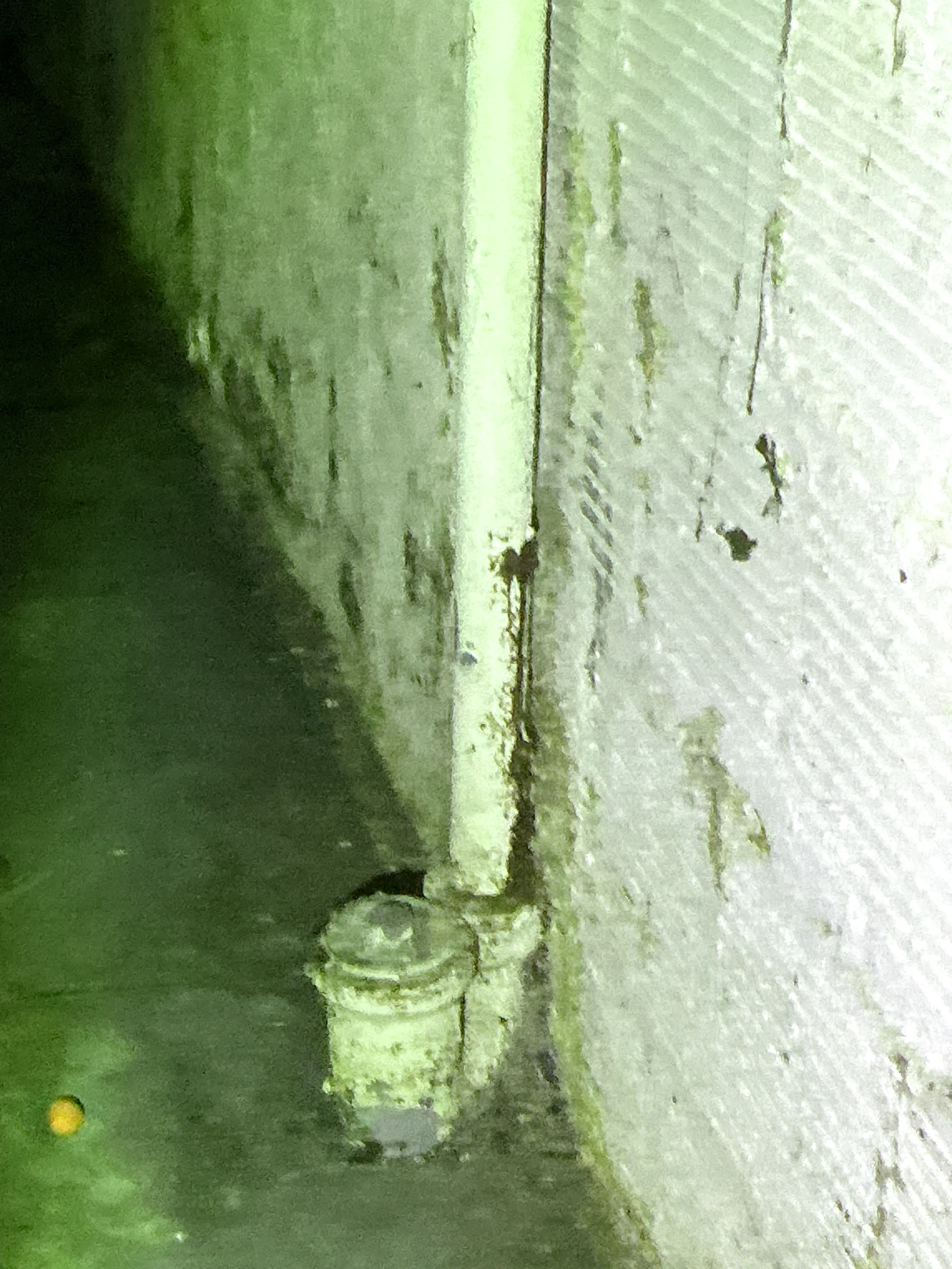 Corroded pipe conduit and connector fitting under structure during indoor air quality testing 2026-08-12