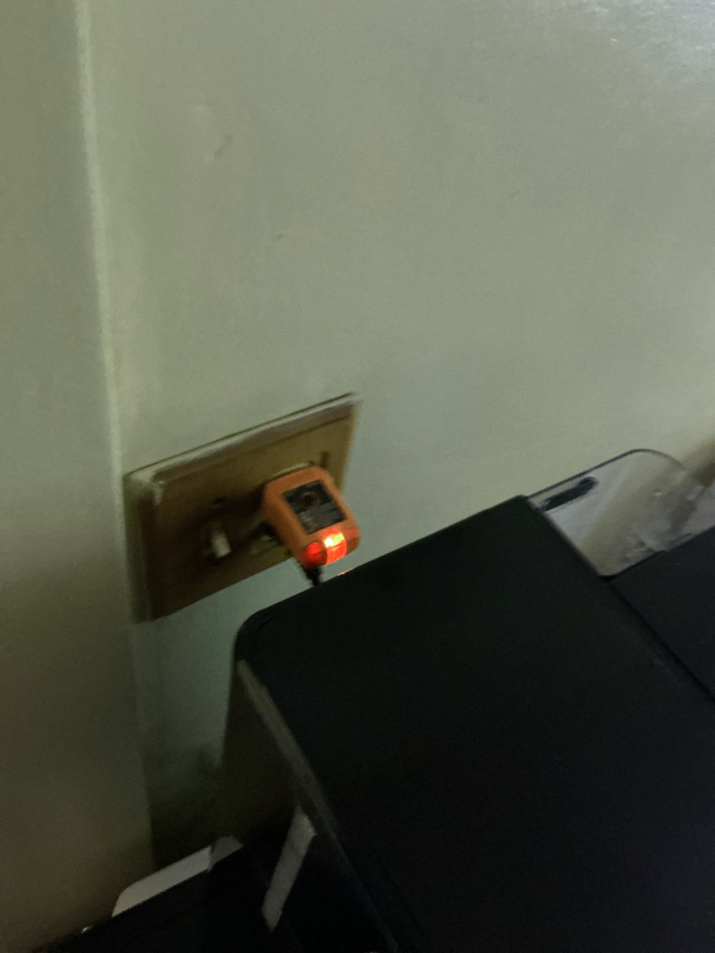 Electrical circuit tester plugged into a wall outlet during a lead inspection 2026-07-18
