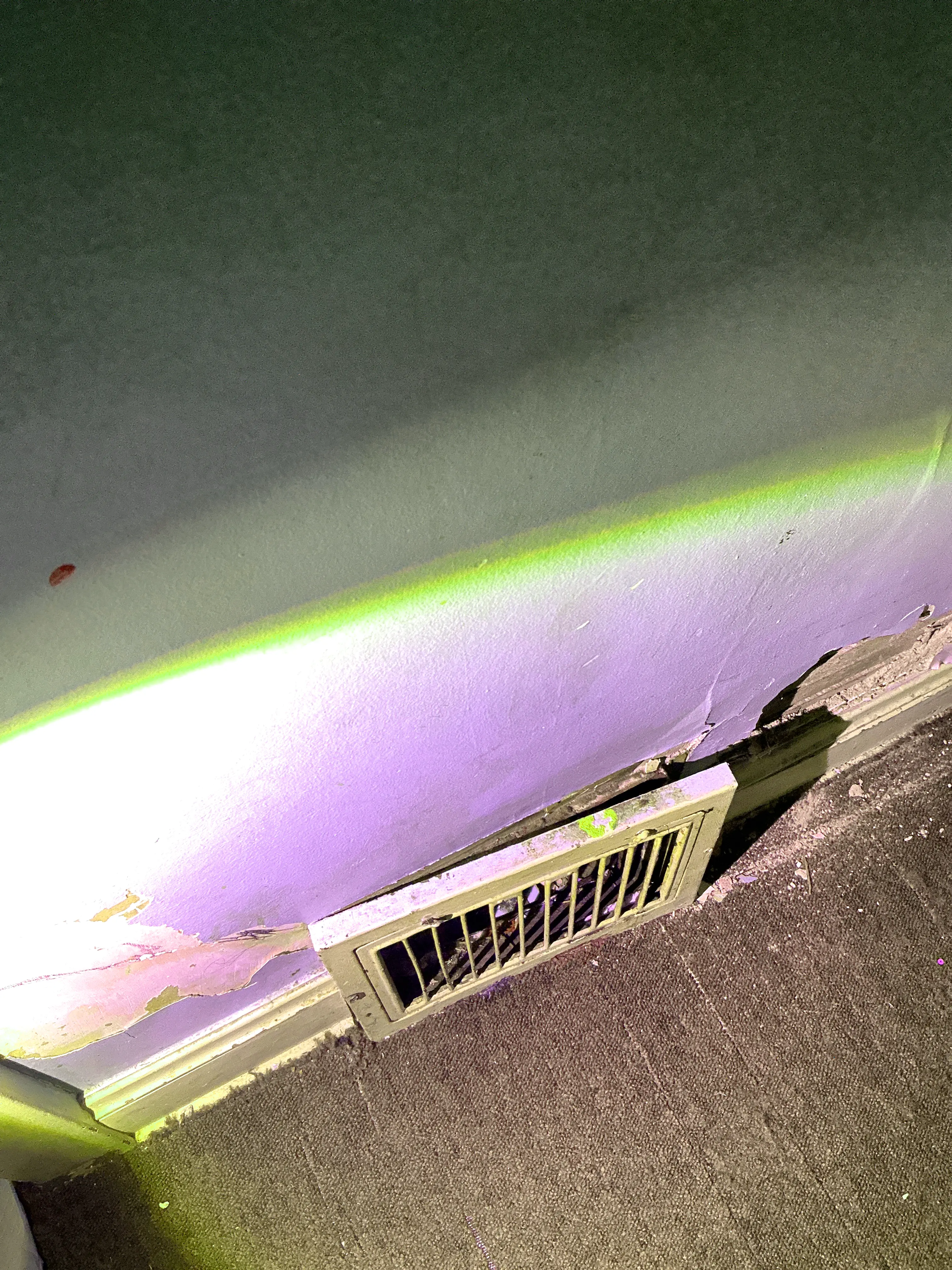 Peeling paint and drywall damage near floor vent register during mold inspection 2026-08-23