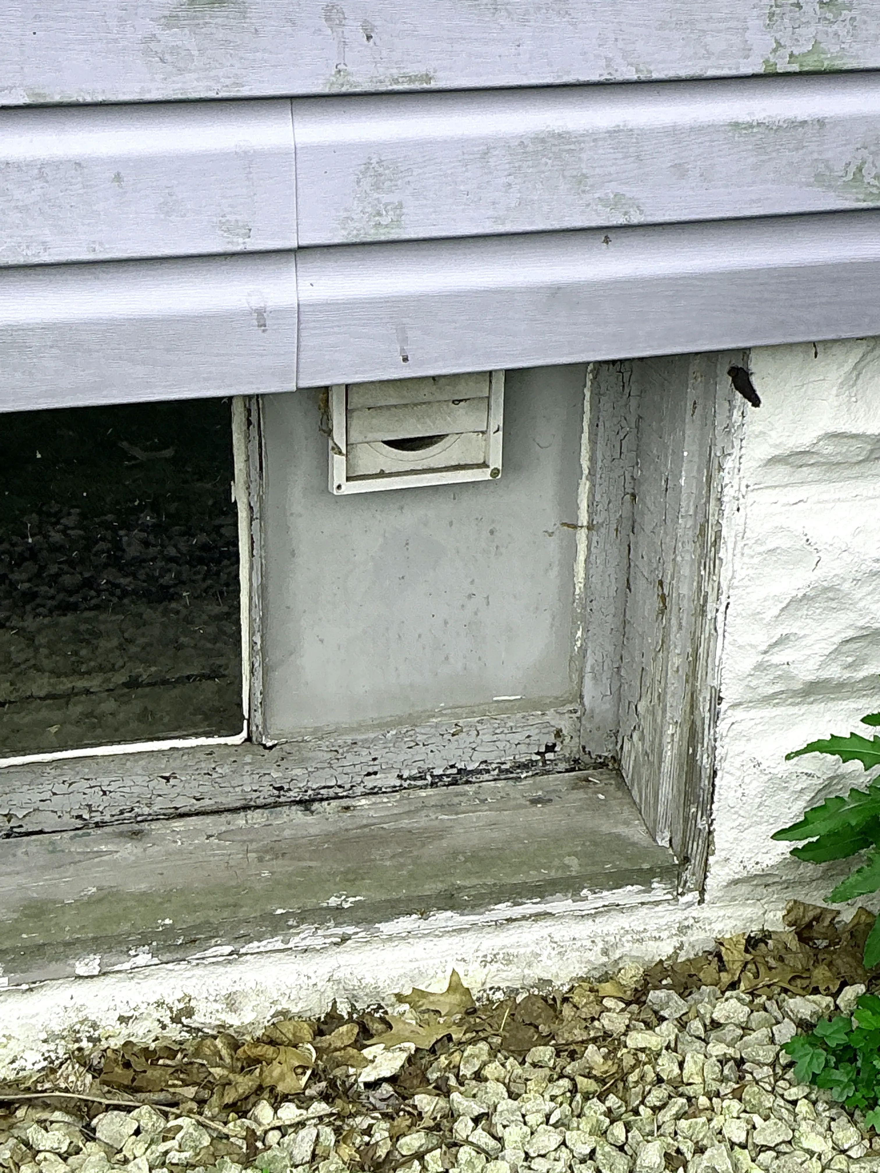 Partially blocked exterior vent and peeling paint on window frame during mold inspection 2026-08-26