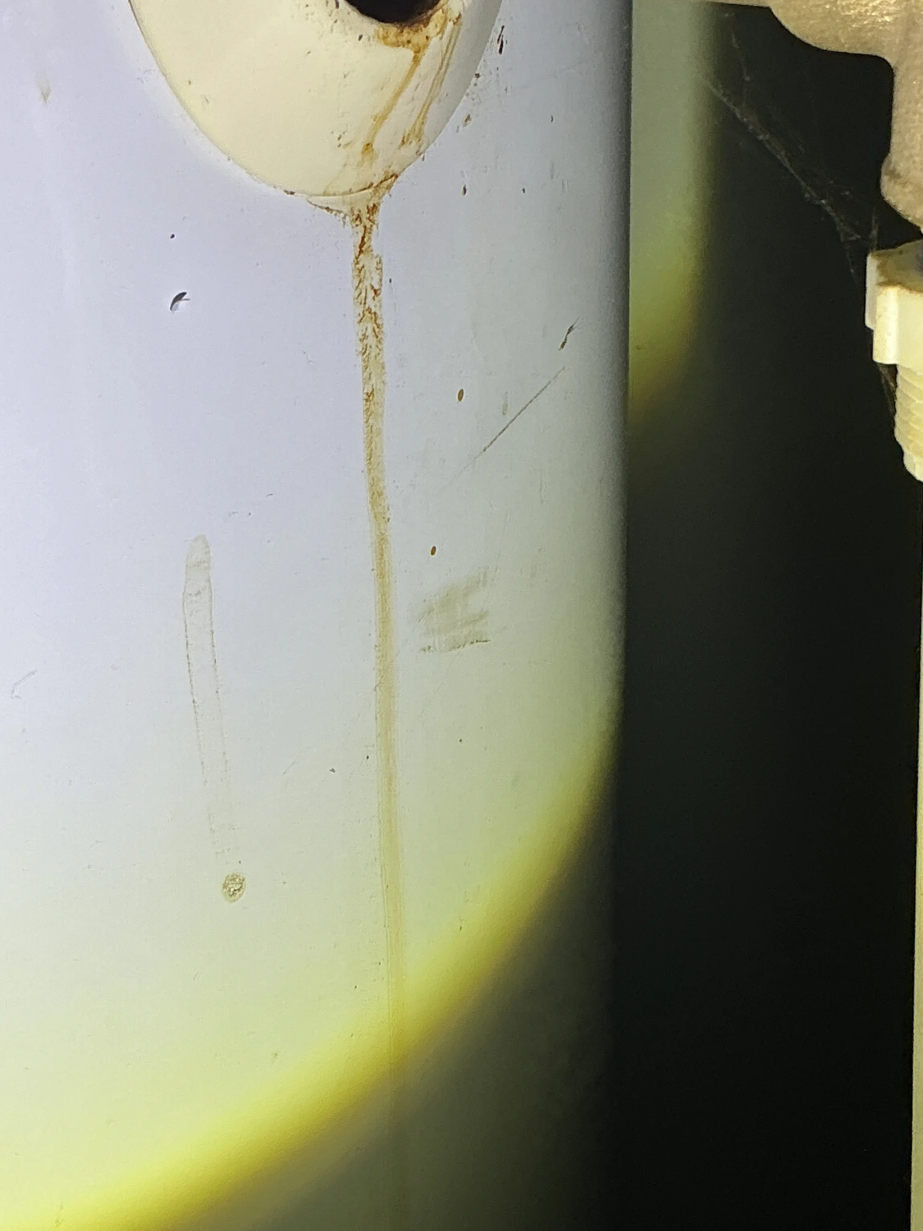Water stain on the underside of a sink fixture indicating a plumbing leak 2026-08-18