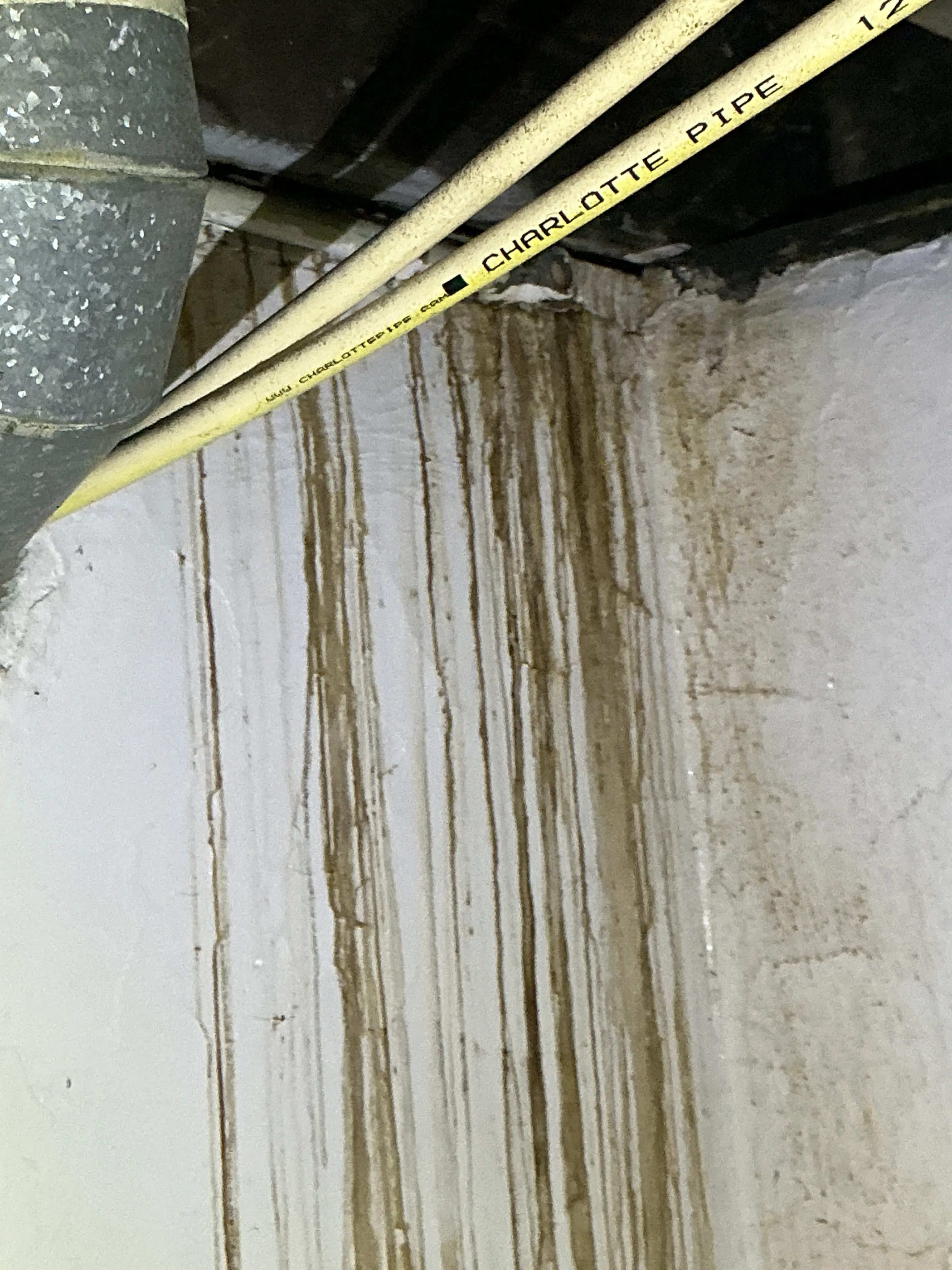 Water staining and moisture damage on ceiling joists near plumbing pipes 2026-07-21