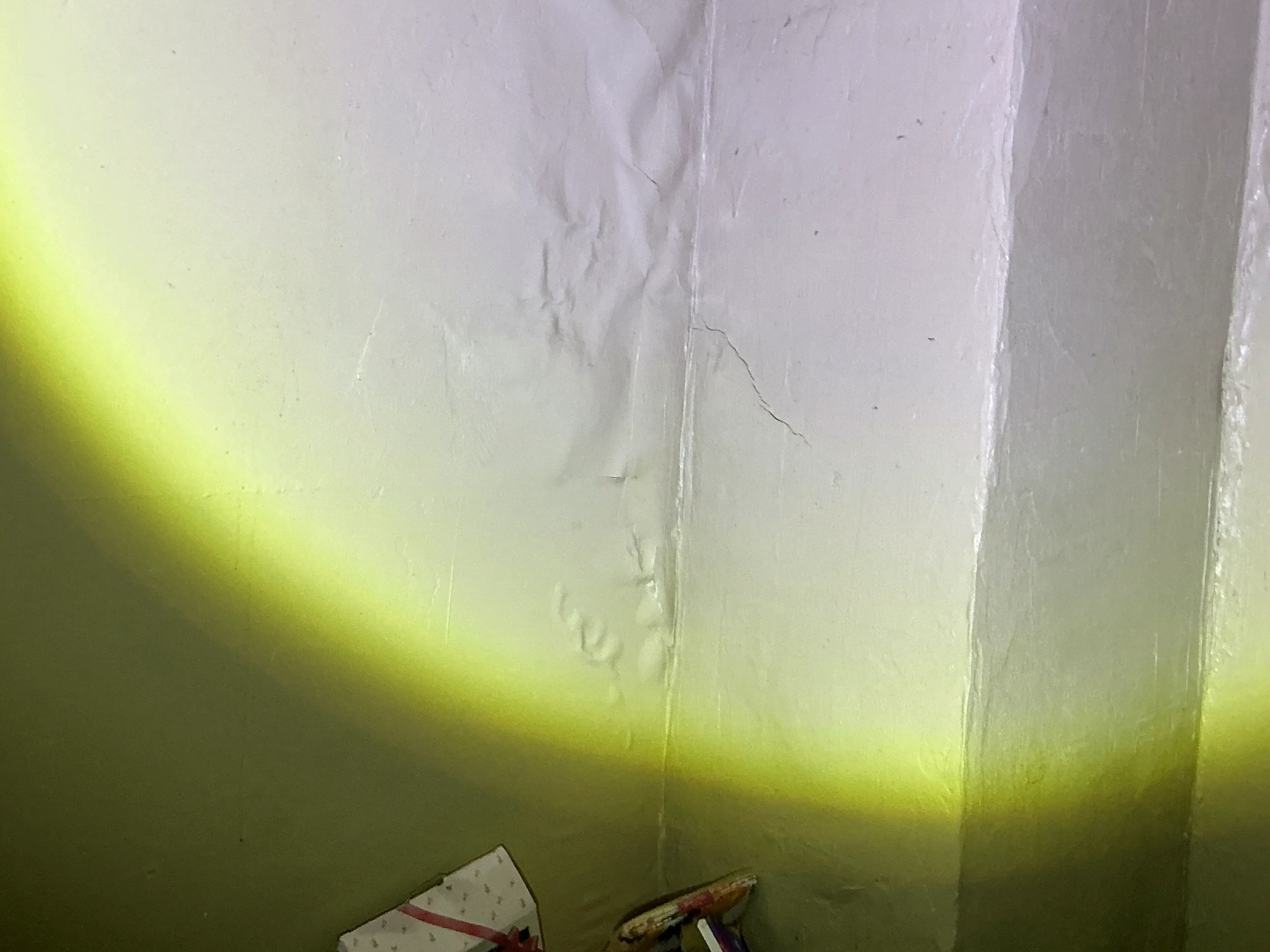 Peeling and bubbling paint on wall indicating possible moisture intrusion 2026-08-21