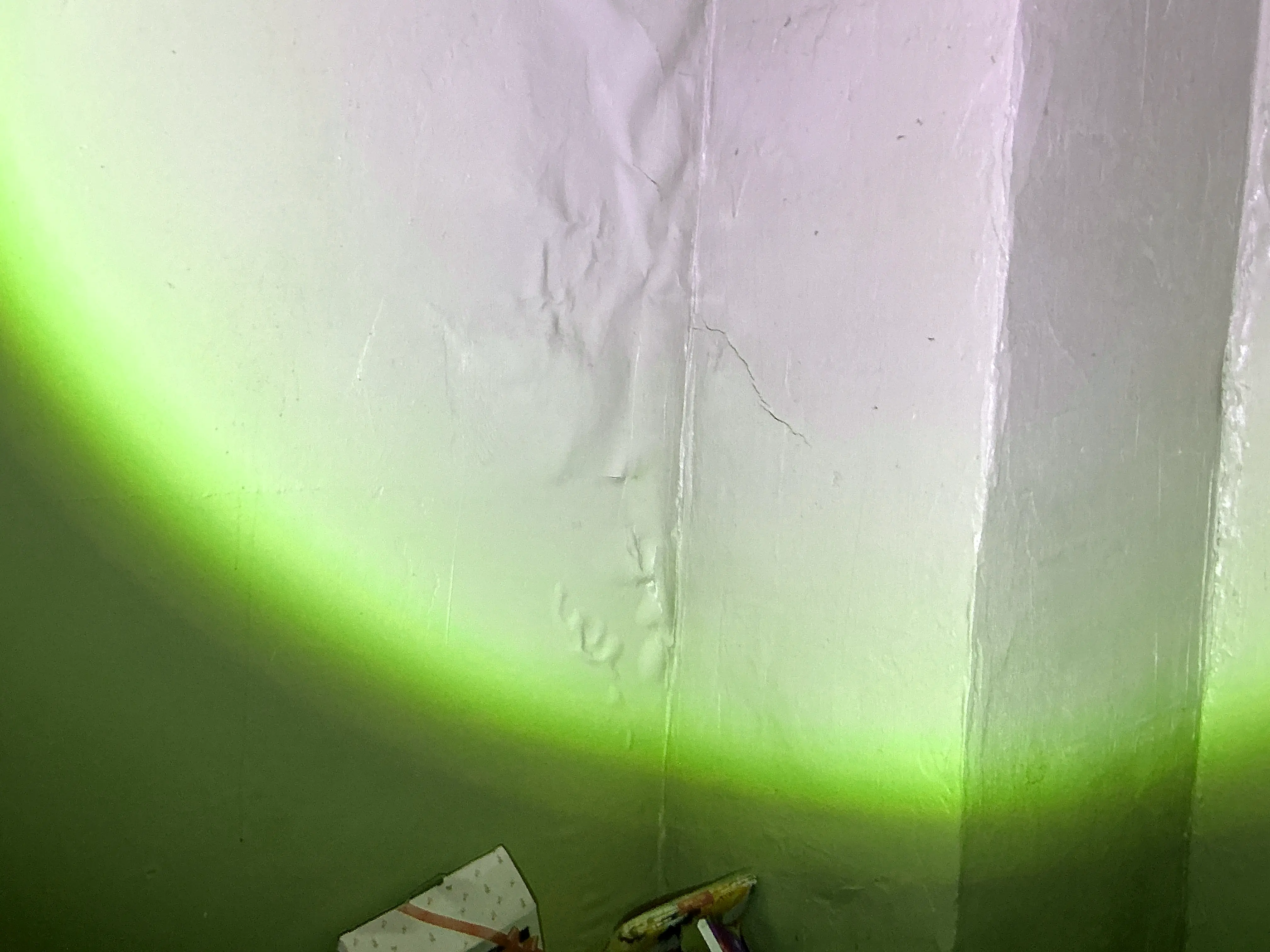 Peeling and bubbling paint on wall indicating possible moisture intrusion 2026-07-14