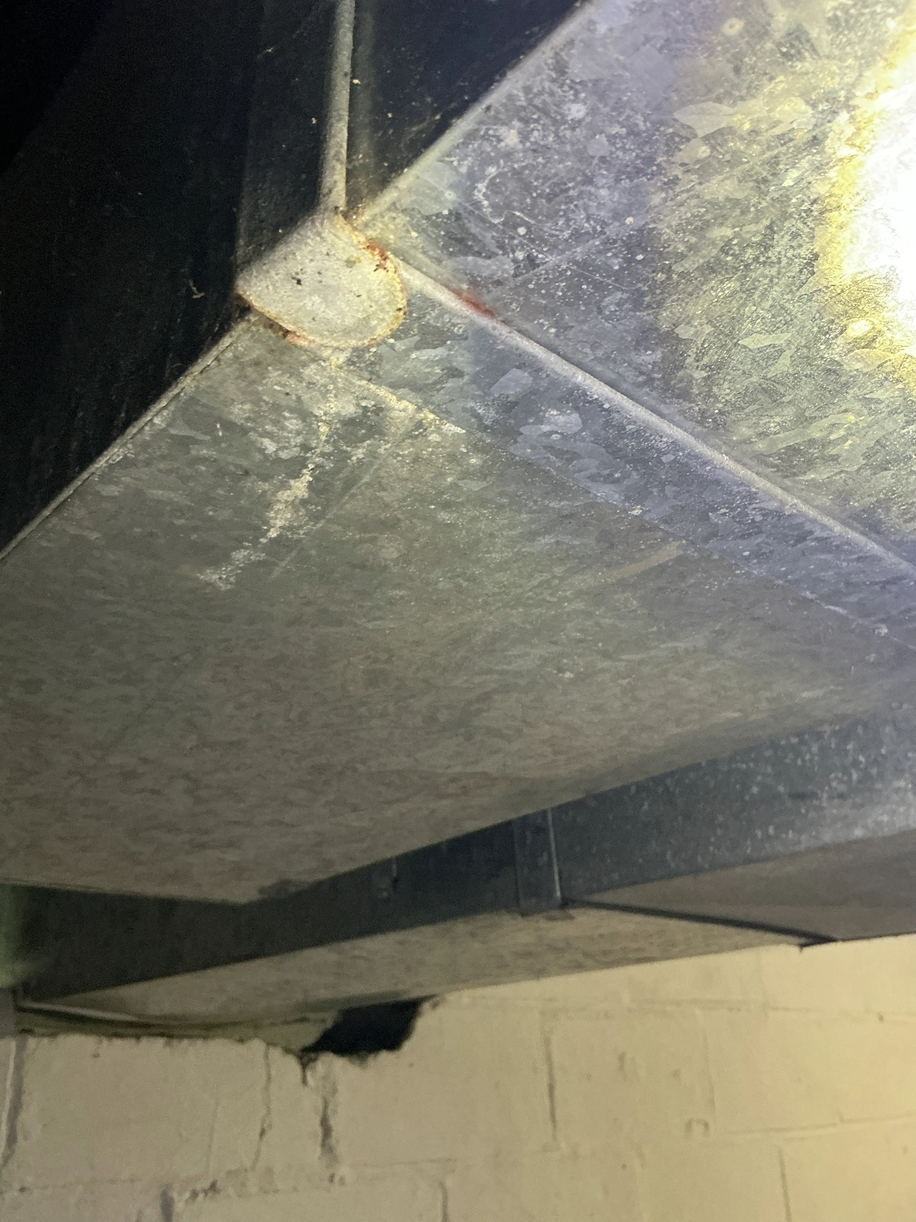 Surface rust and corrosion on galvanized sheet metal HVAC ductwork seam 2026-08-06