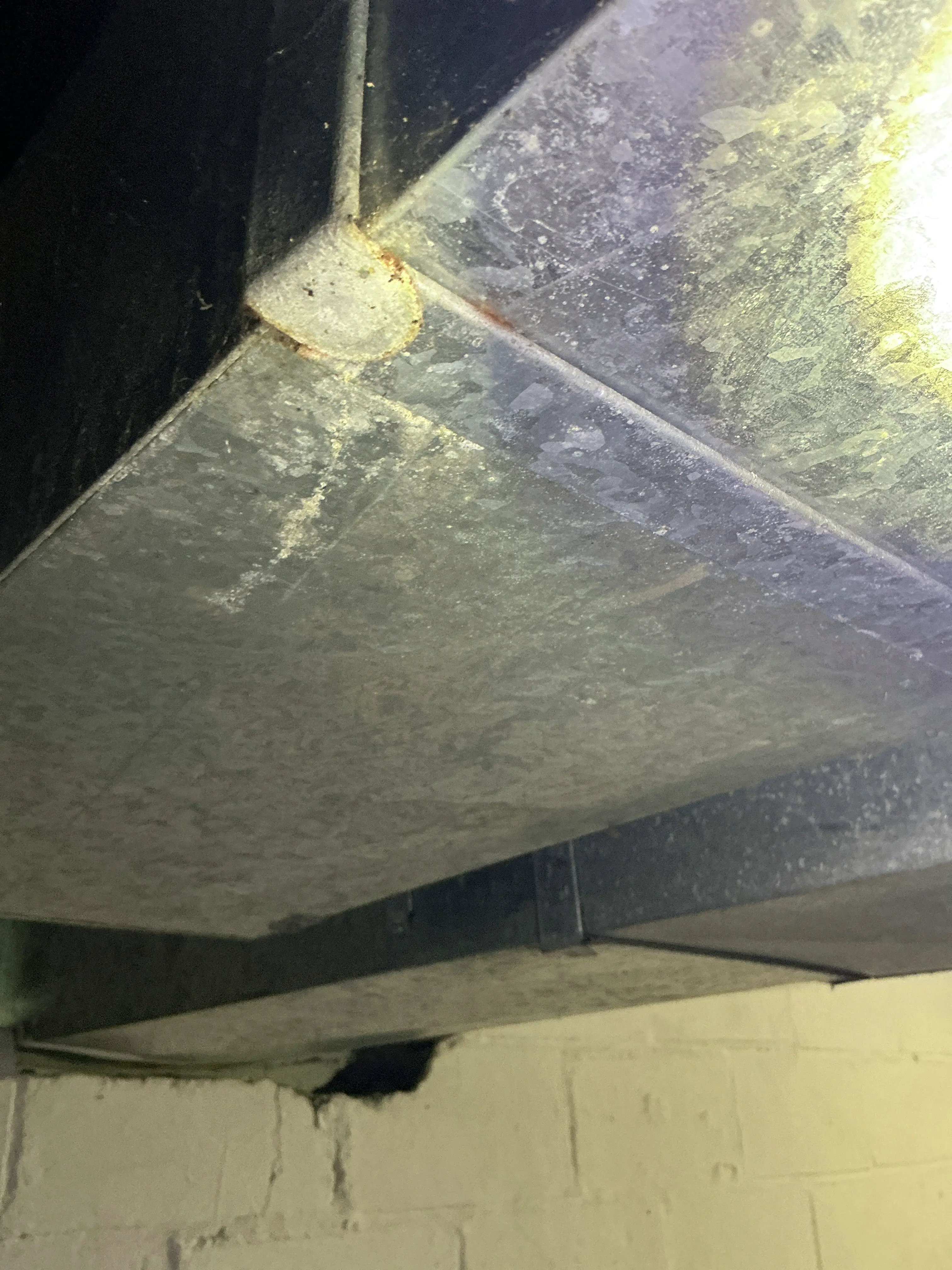 Surface rust and corrosion on galvanized sheet metal HVAC ductwork seam 2026-08-20