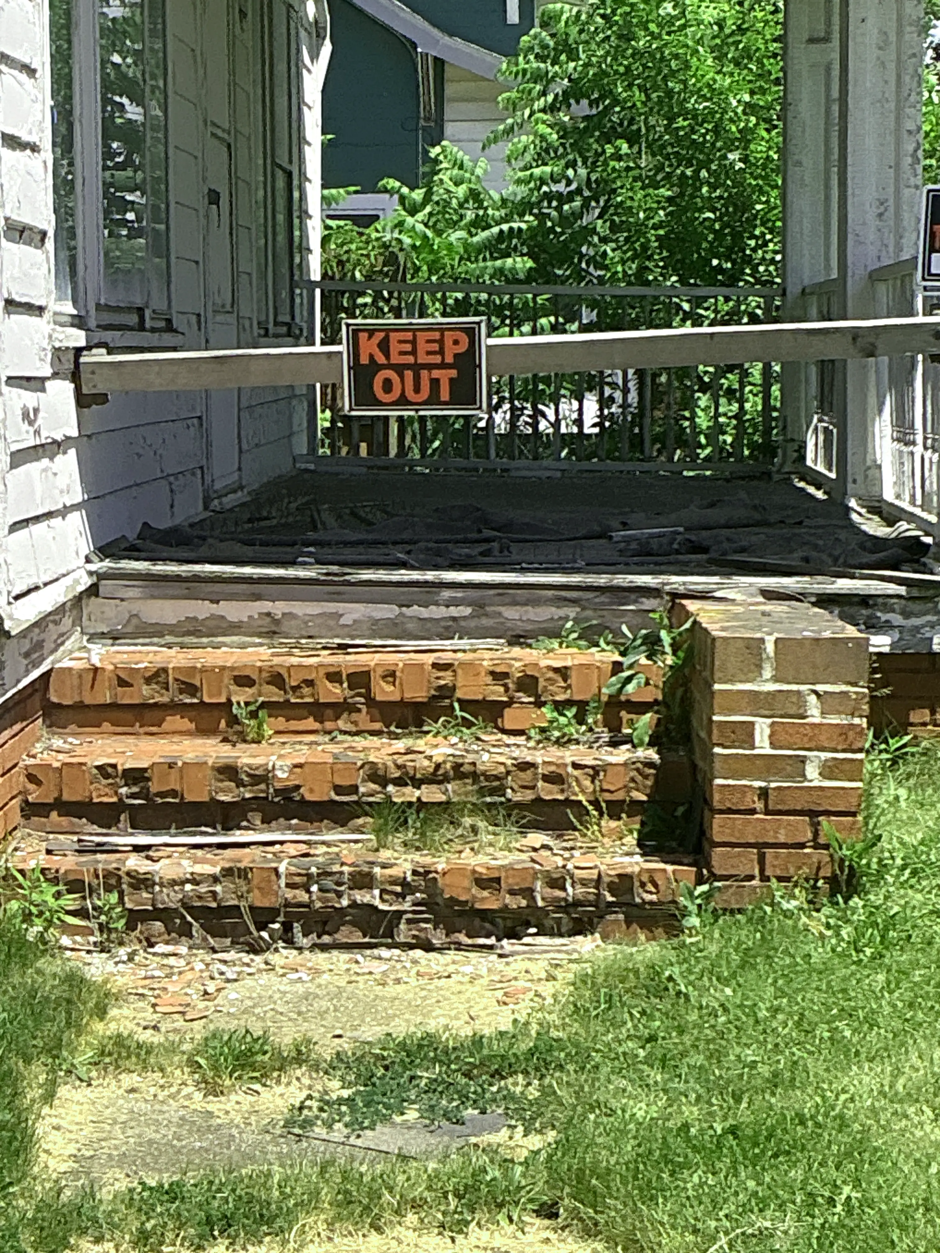 Hazardous crumbling brick steps and damaged wooden porch structure noted during mold testing 2026-07-22