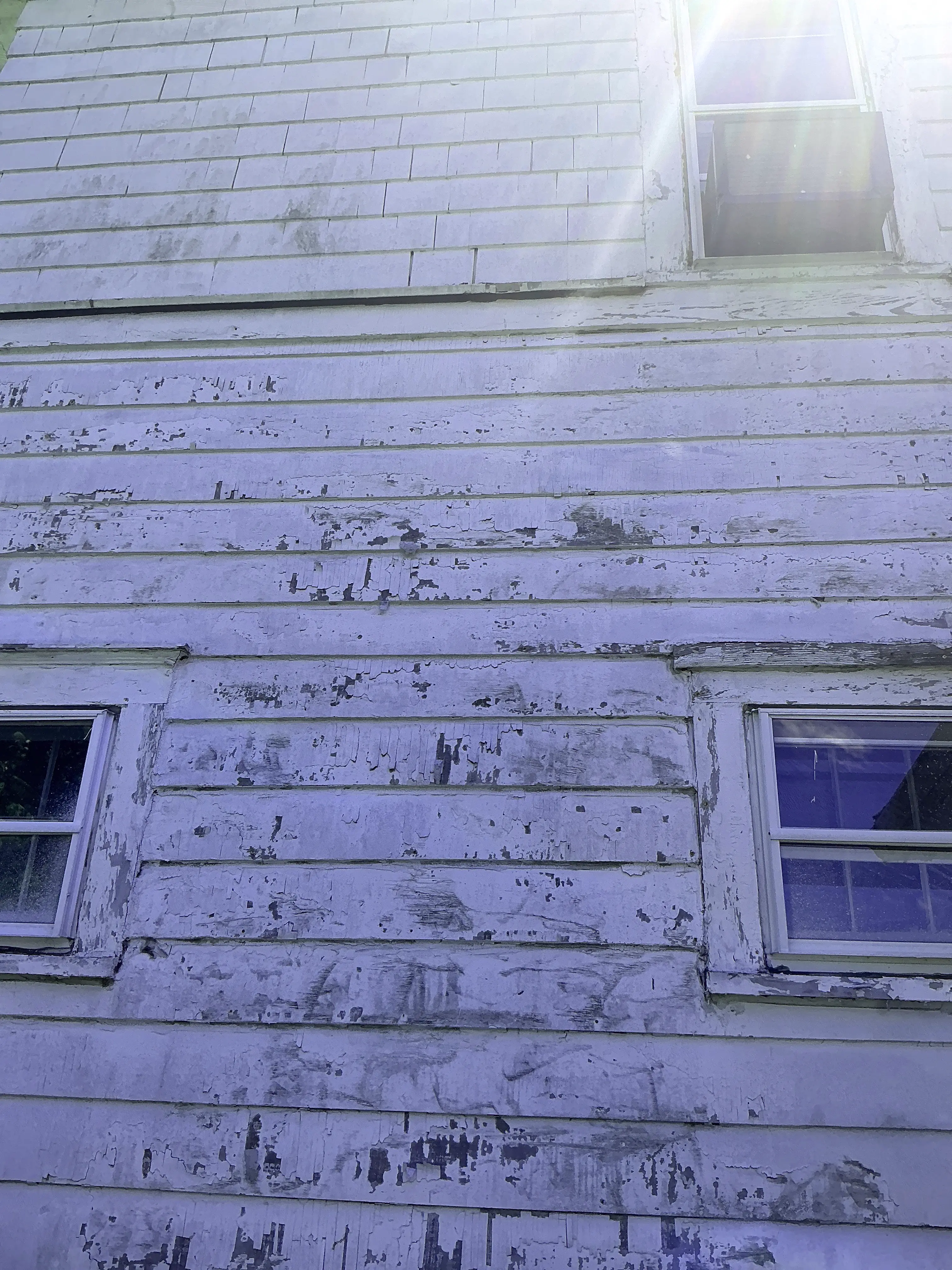 Peeling exterior paint on wood wall siding during a home inspection 2026-08-22