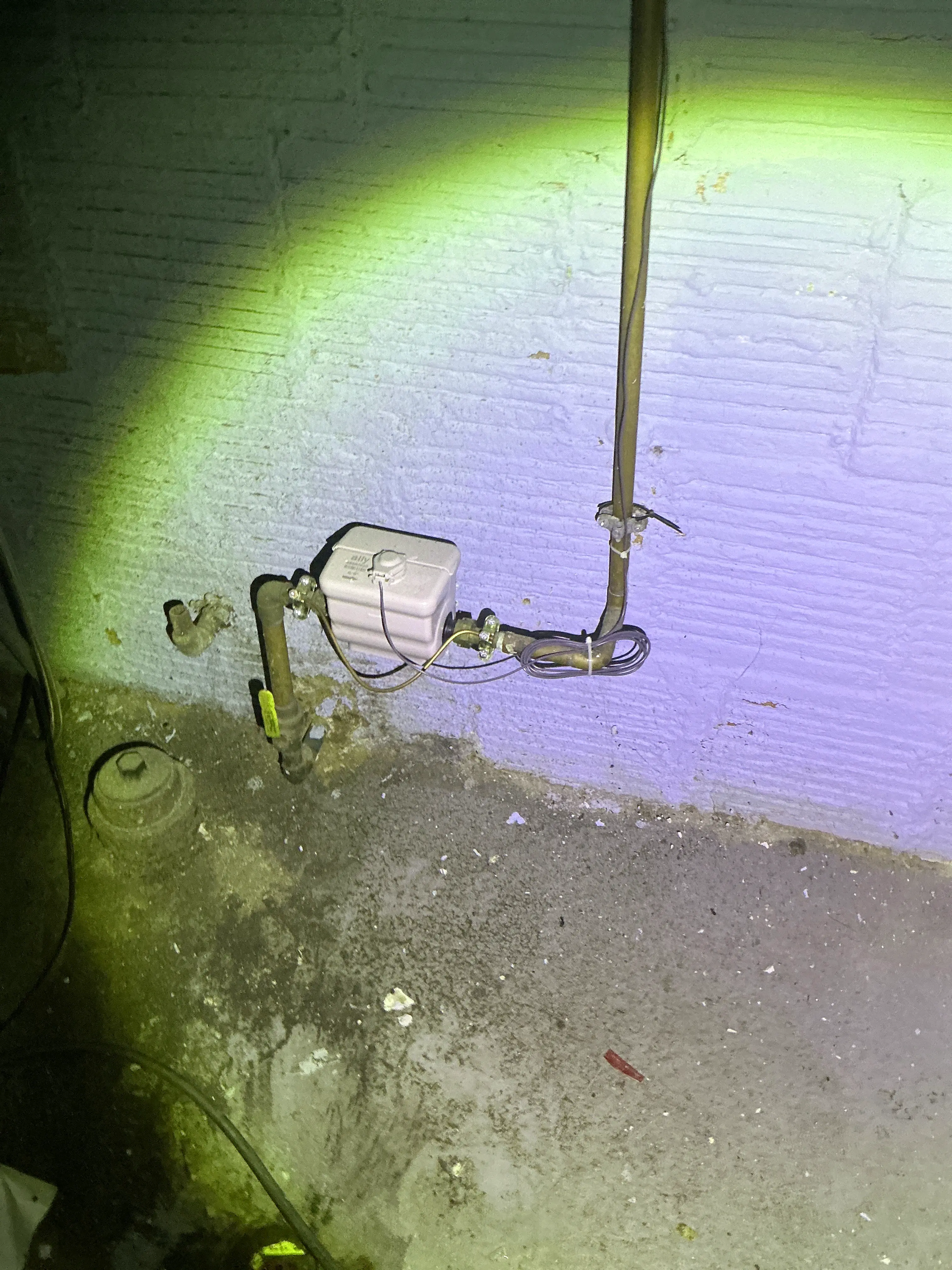 Water main shutoff valve and meter assembly with electrical bonding wire in a basement 2026-08-29