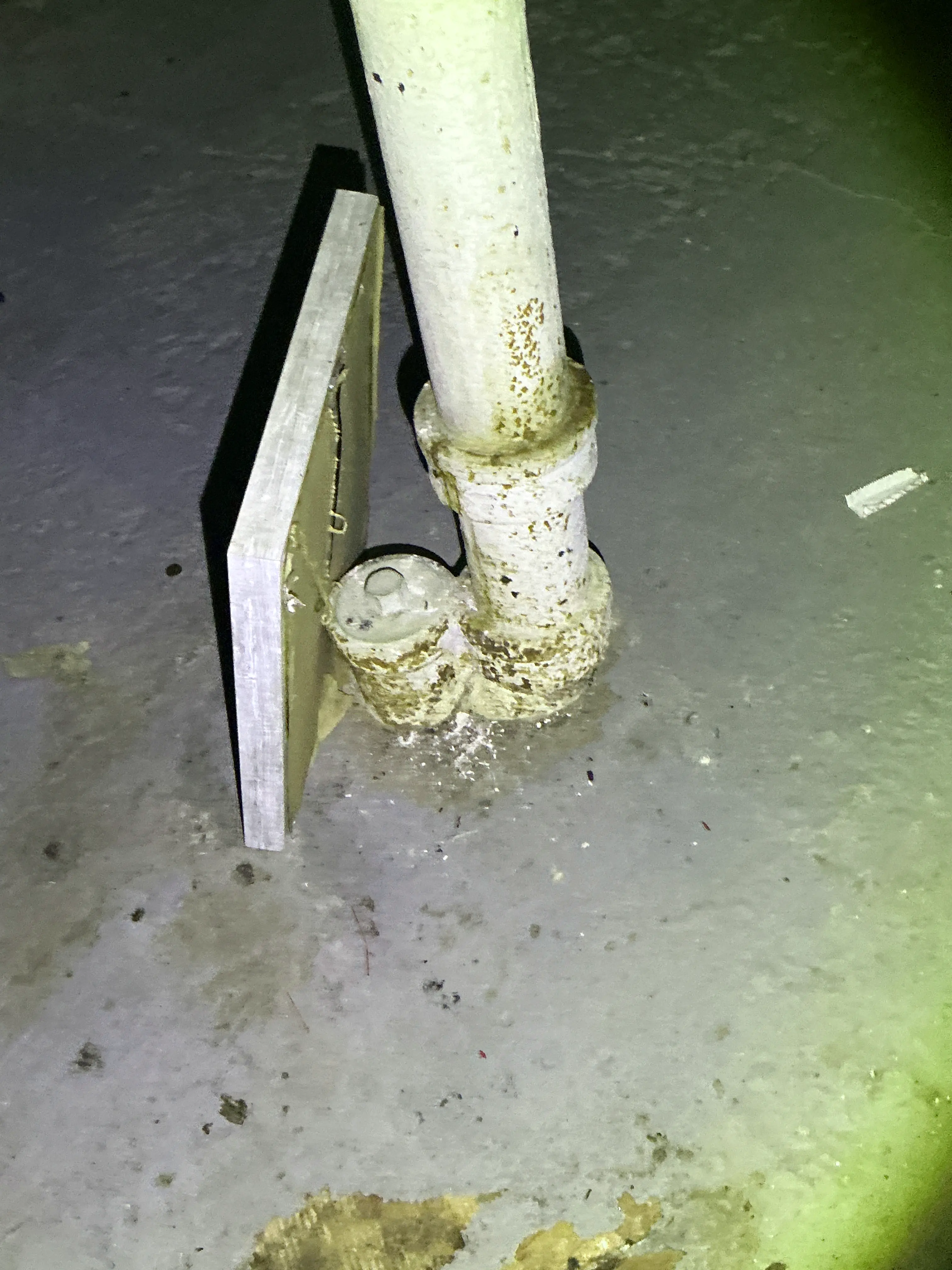 Corroded metal pipe fitting with rust in basement 2026-07-16