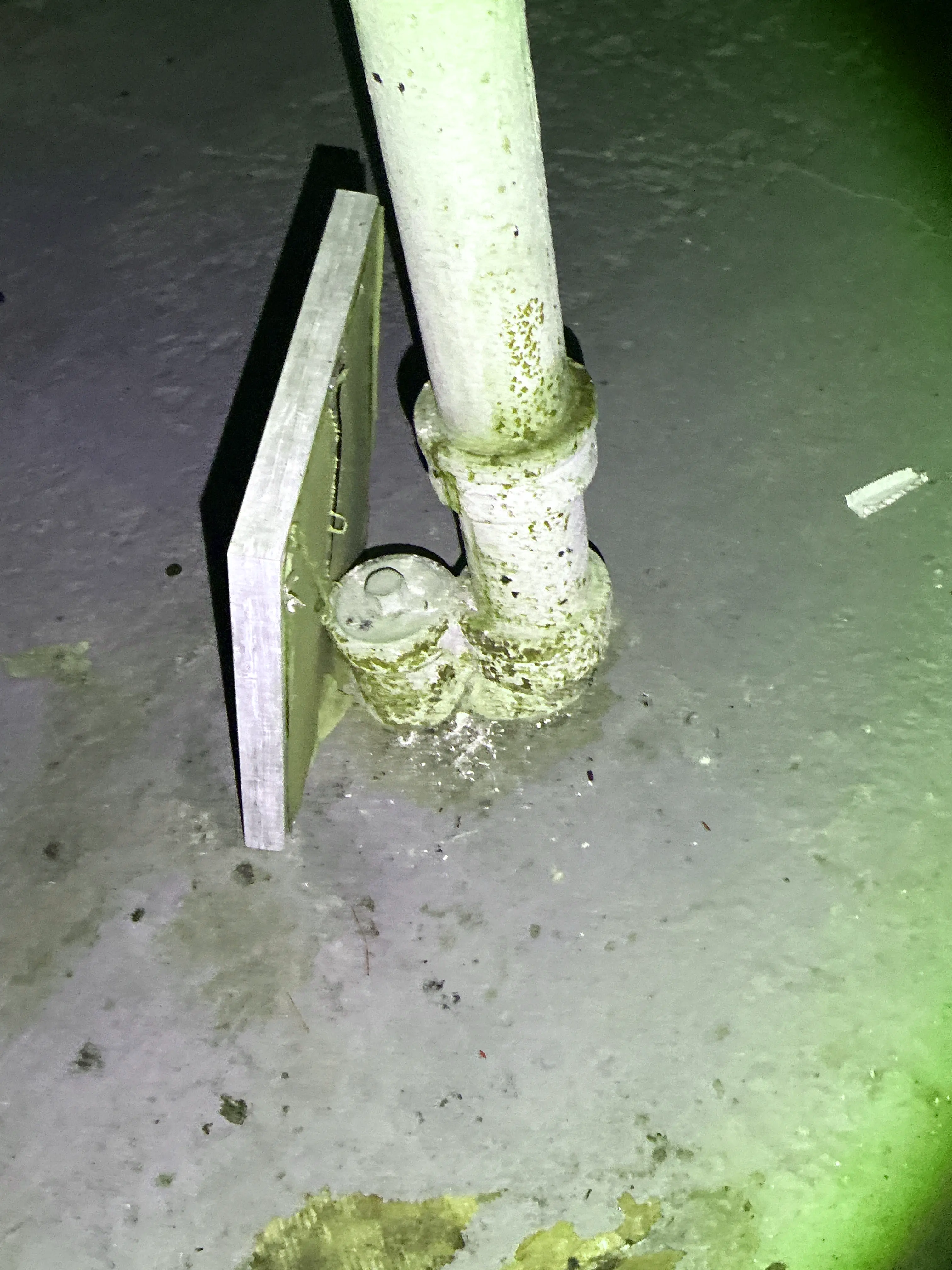 Corroded metal pipe fitting with rust in basement 2026-07-17