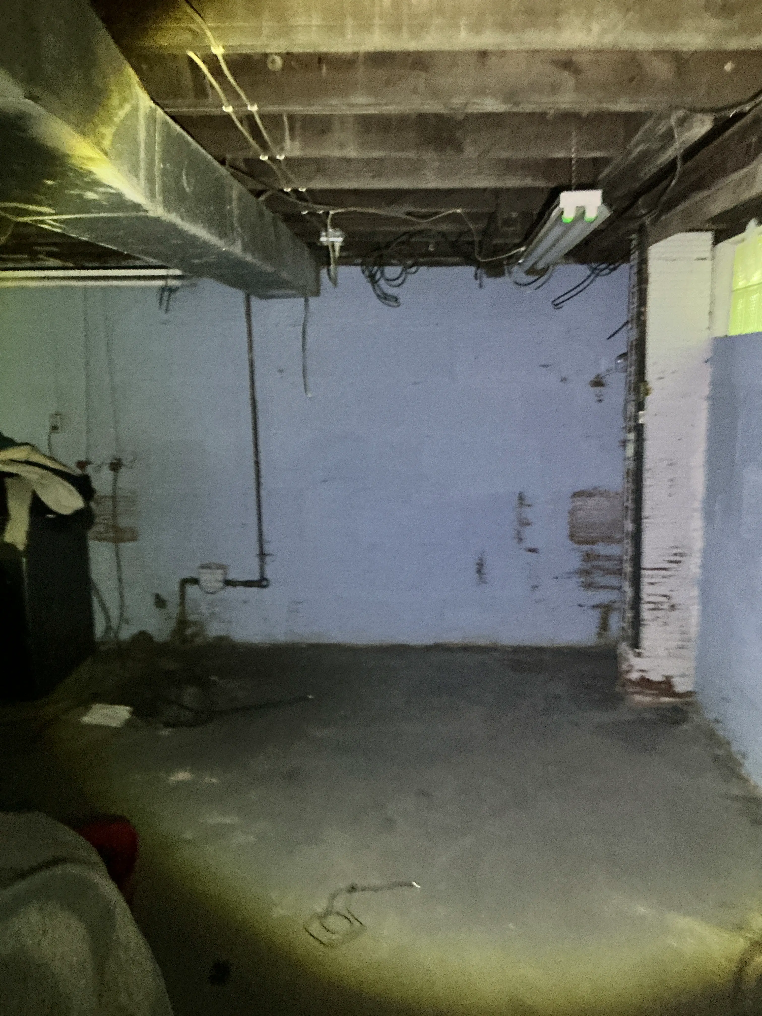 Unfinished basement ceiling joists, HVAC ductwork, and exposed wiring during a general inspection 2026-07-17