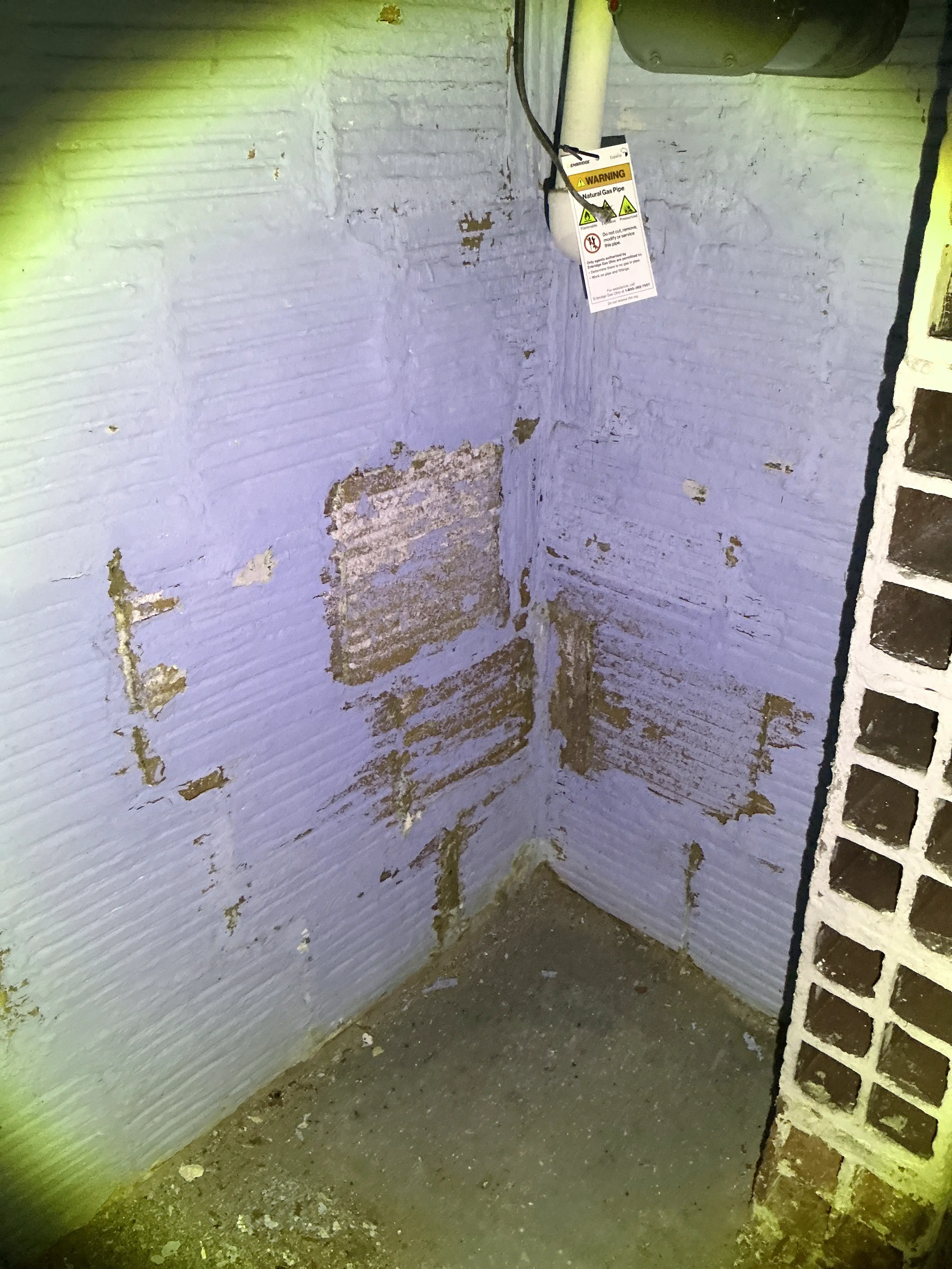 Peeling paint and moisture damage on painted masonry basement wall 2026-08-12