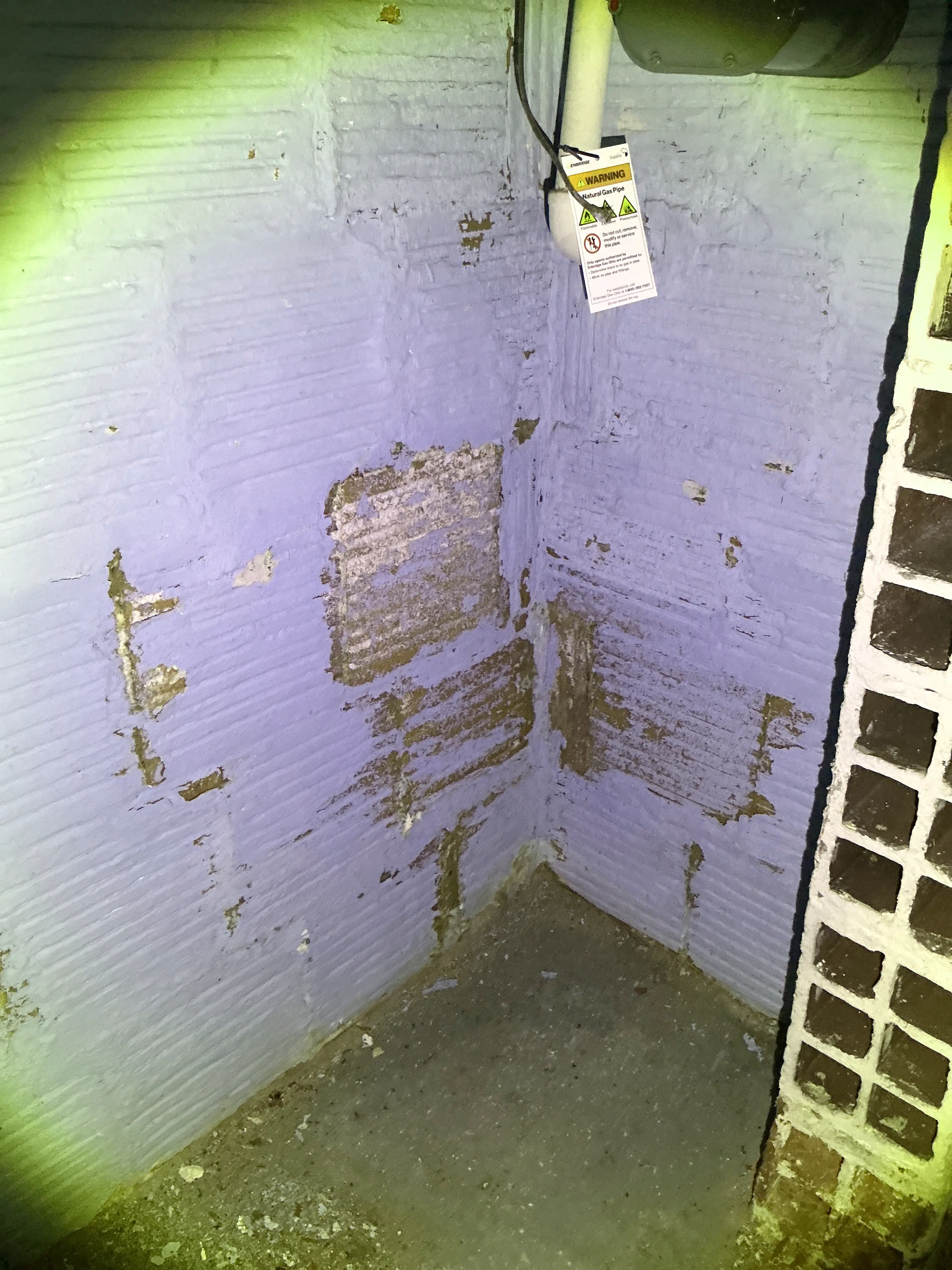 Peeling paint and moisture damage on painted masonry basement wall 2026-09-01