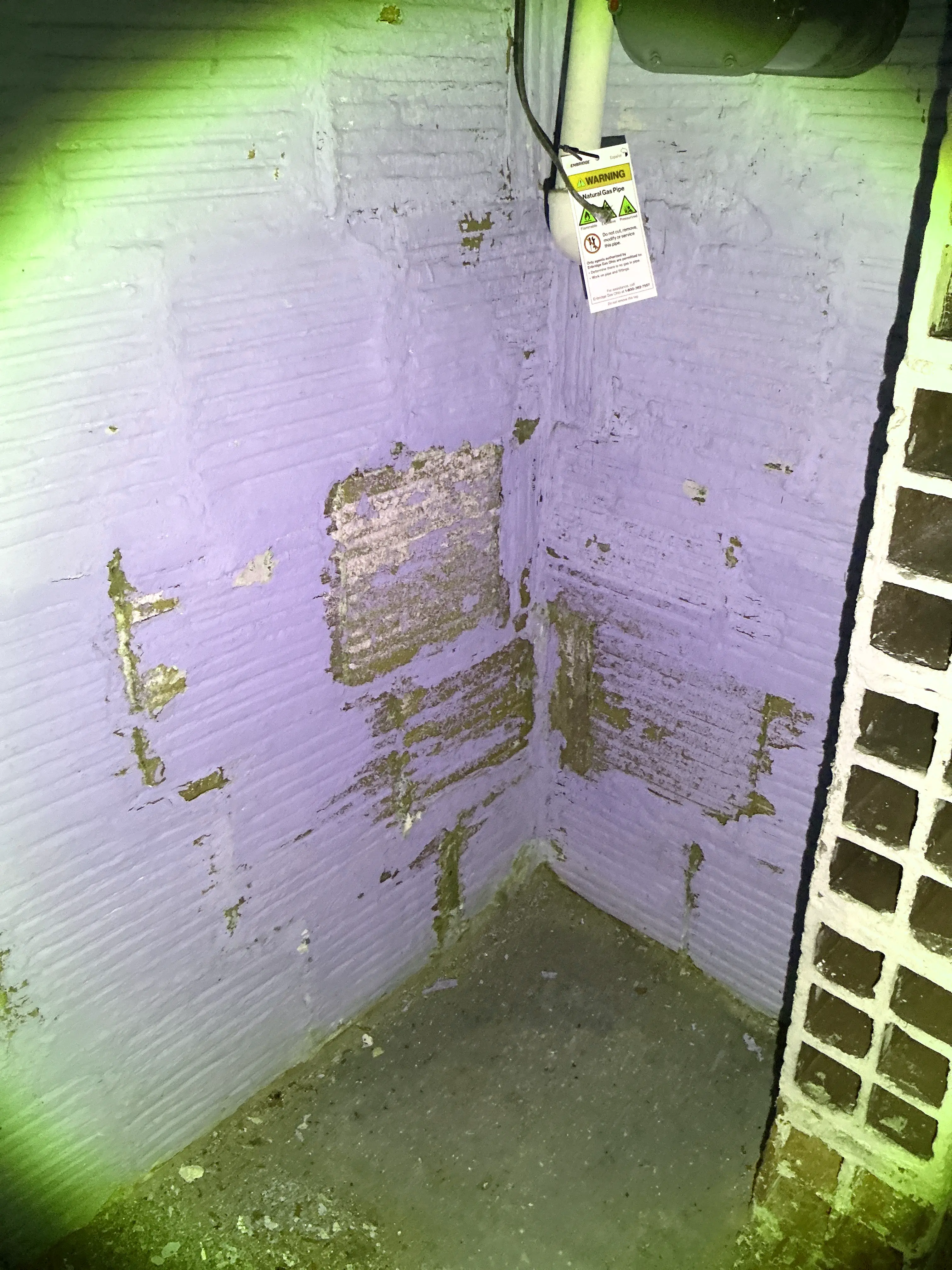 Peeling paint and moisture damage on painted masonry basement wall 2026-07-21