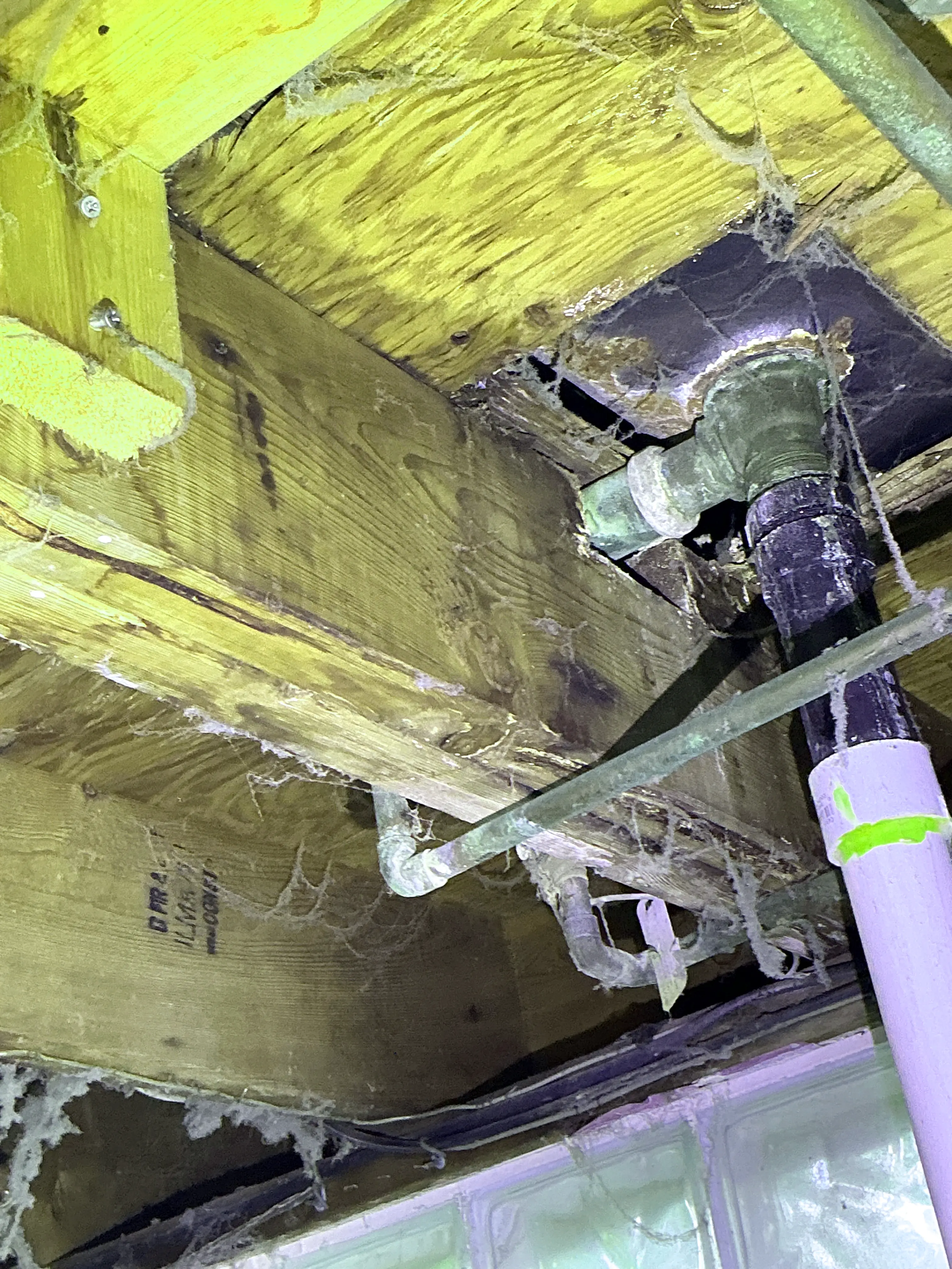 Improperly notched floor joist around plumbing pipes in crawlspace 2026-08-09