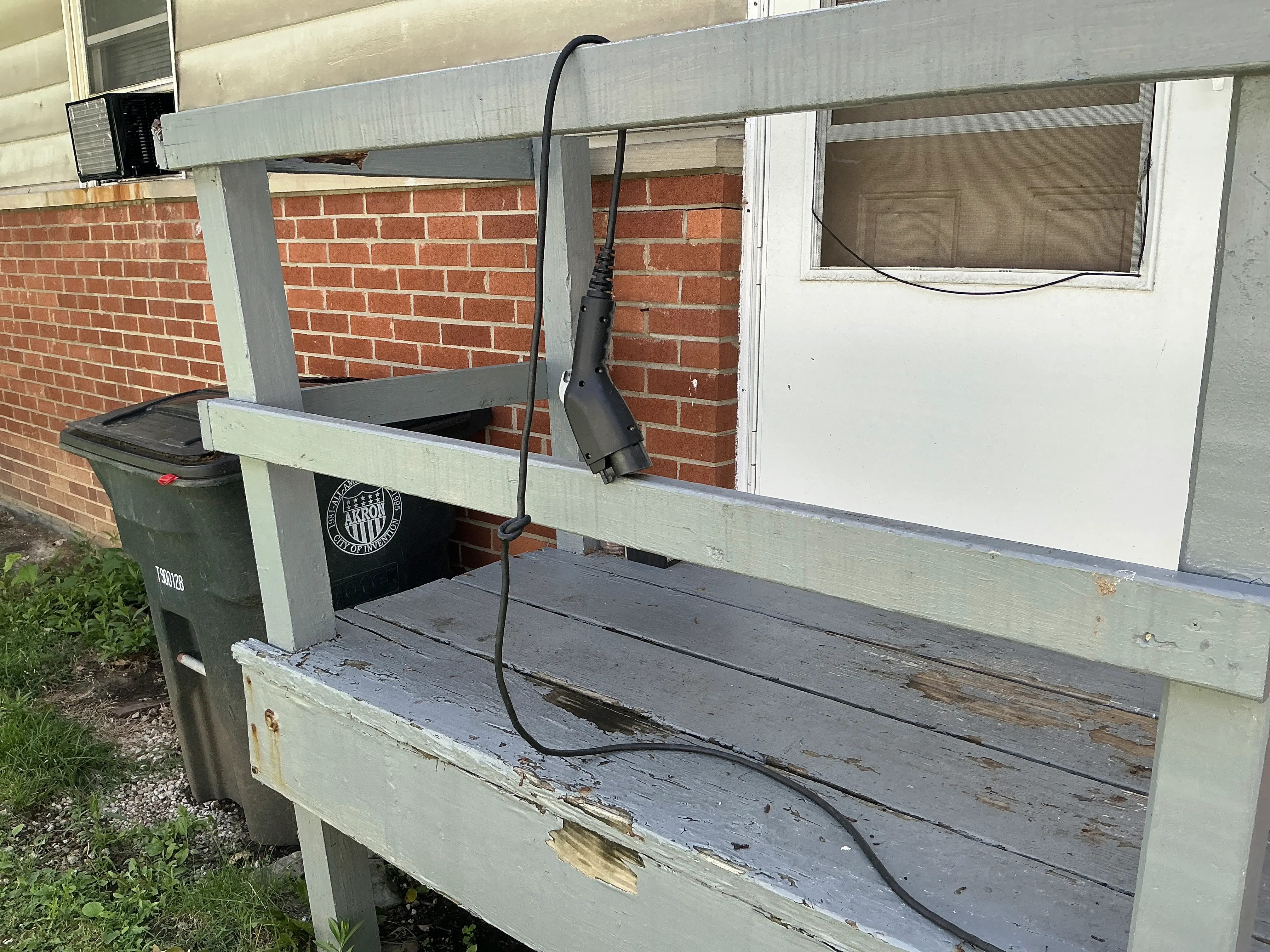 Deteriorated wooden porch structure with peeling paint and damaged wood 2026-08-17