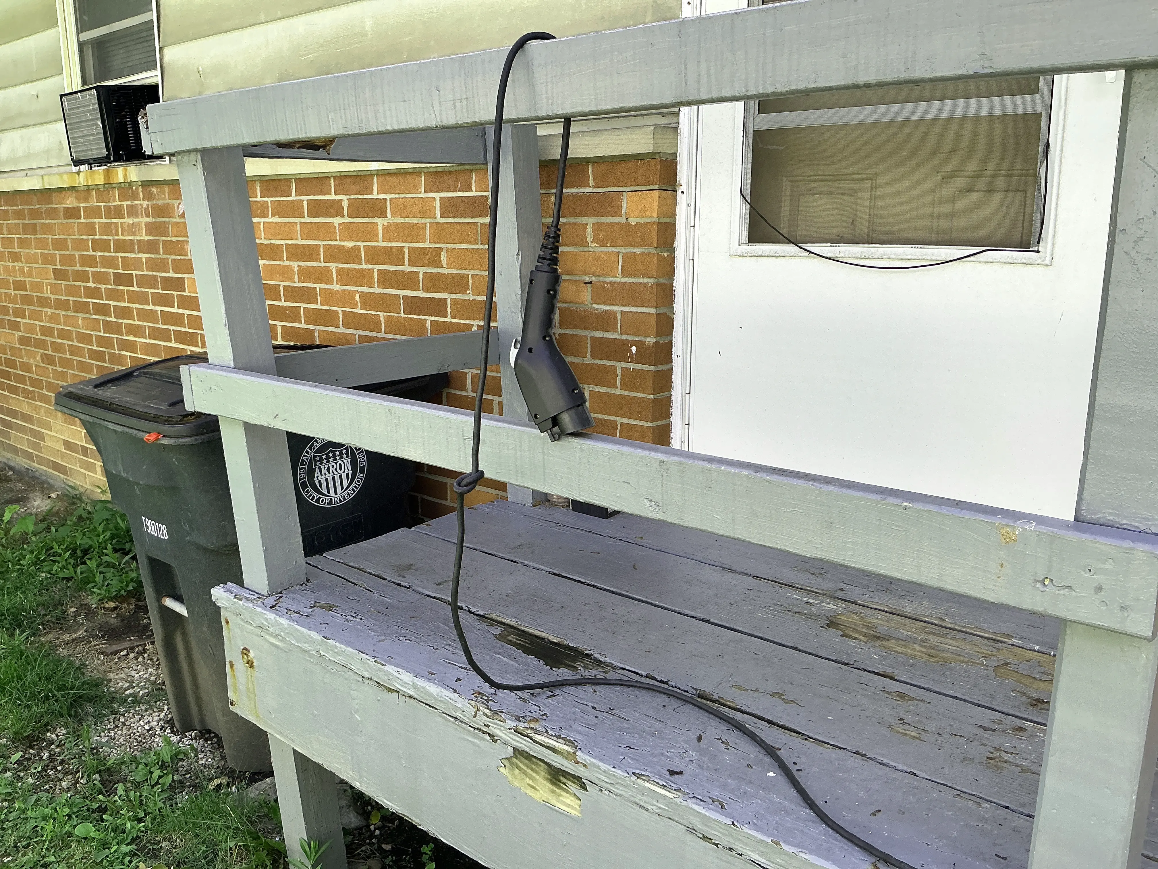 Deteriorated wooden porch structure with peeling paint and damaged wood 2026-07-25