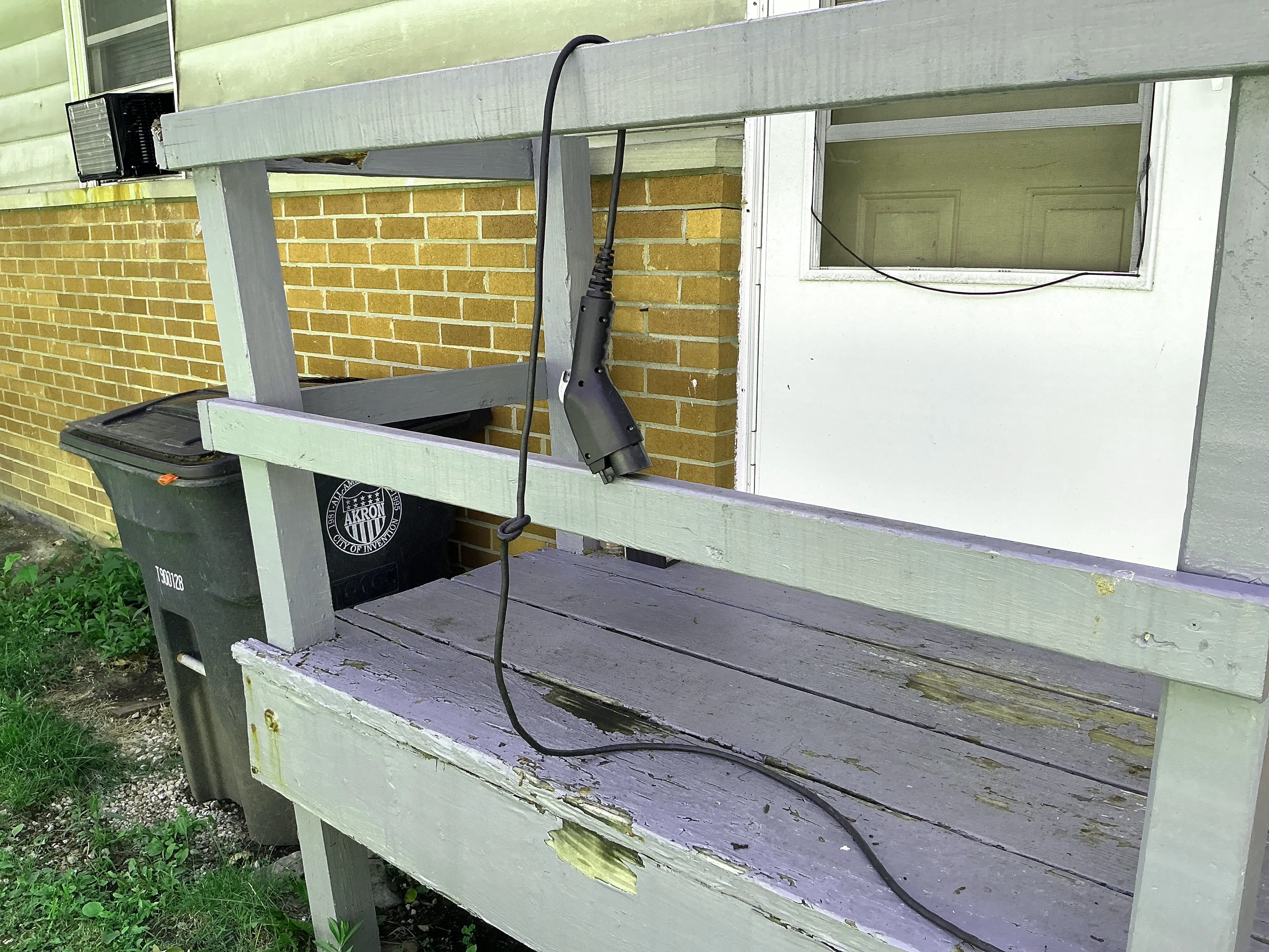 Deteriorated wooden porch structure with peeling paint and damaged wood 2026-07-26