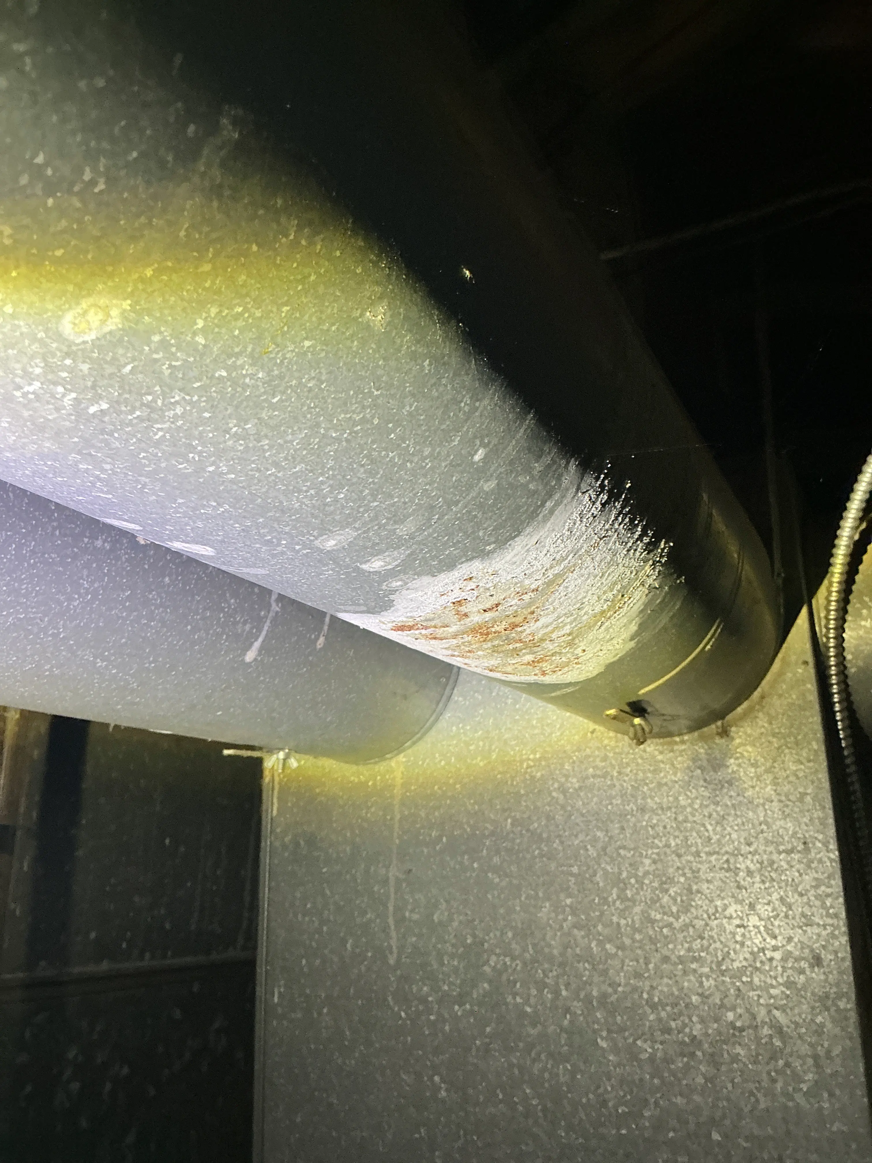 Rusted metal flue pipe and galvanized ductwork inspected during mold testing 2026-07-26