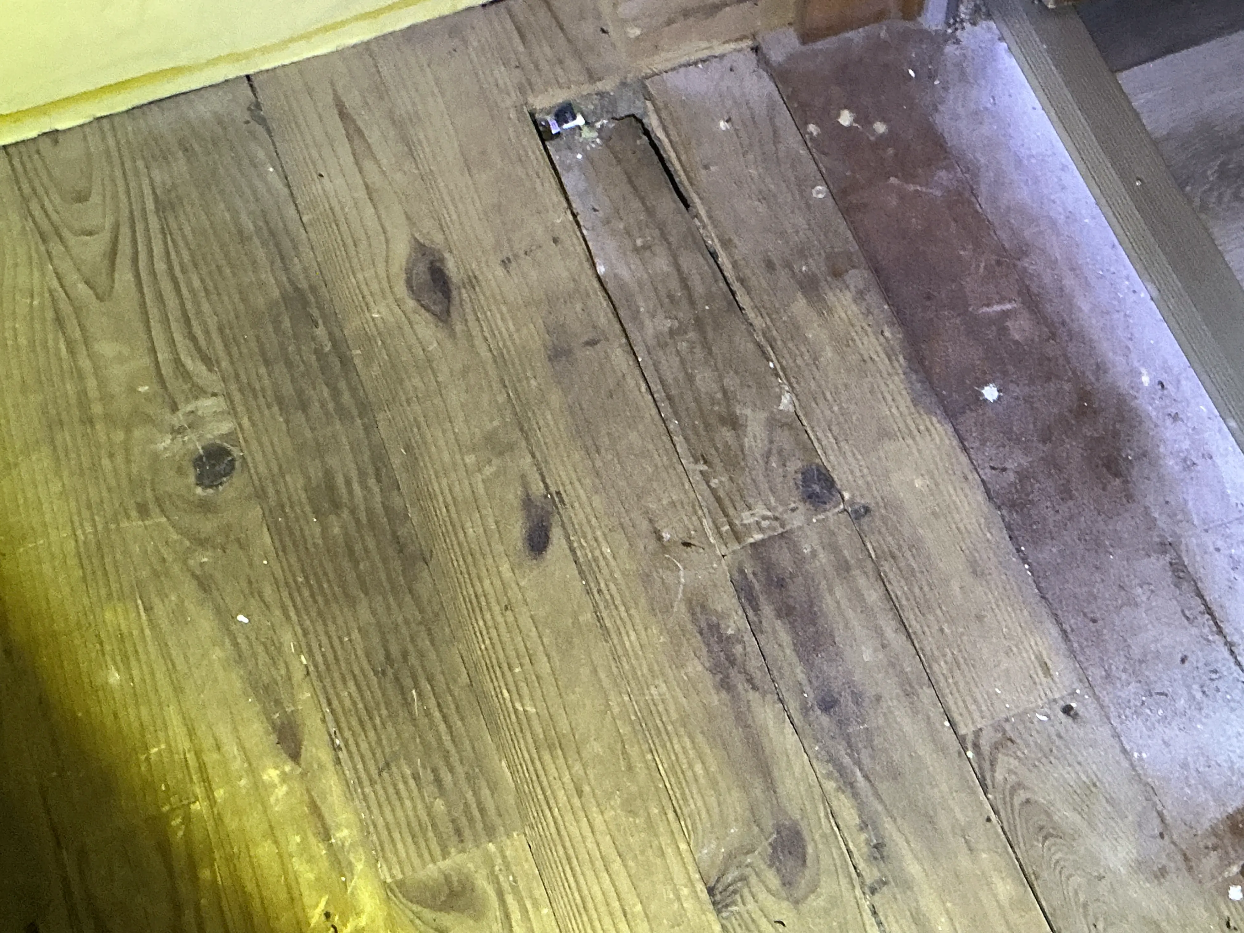 Damaged wood floorboards with gaps and cutouts needing repair 2026-08-28