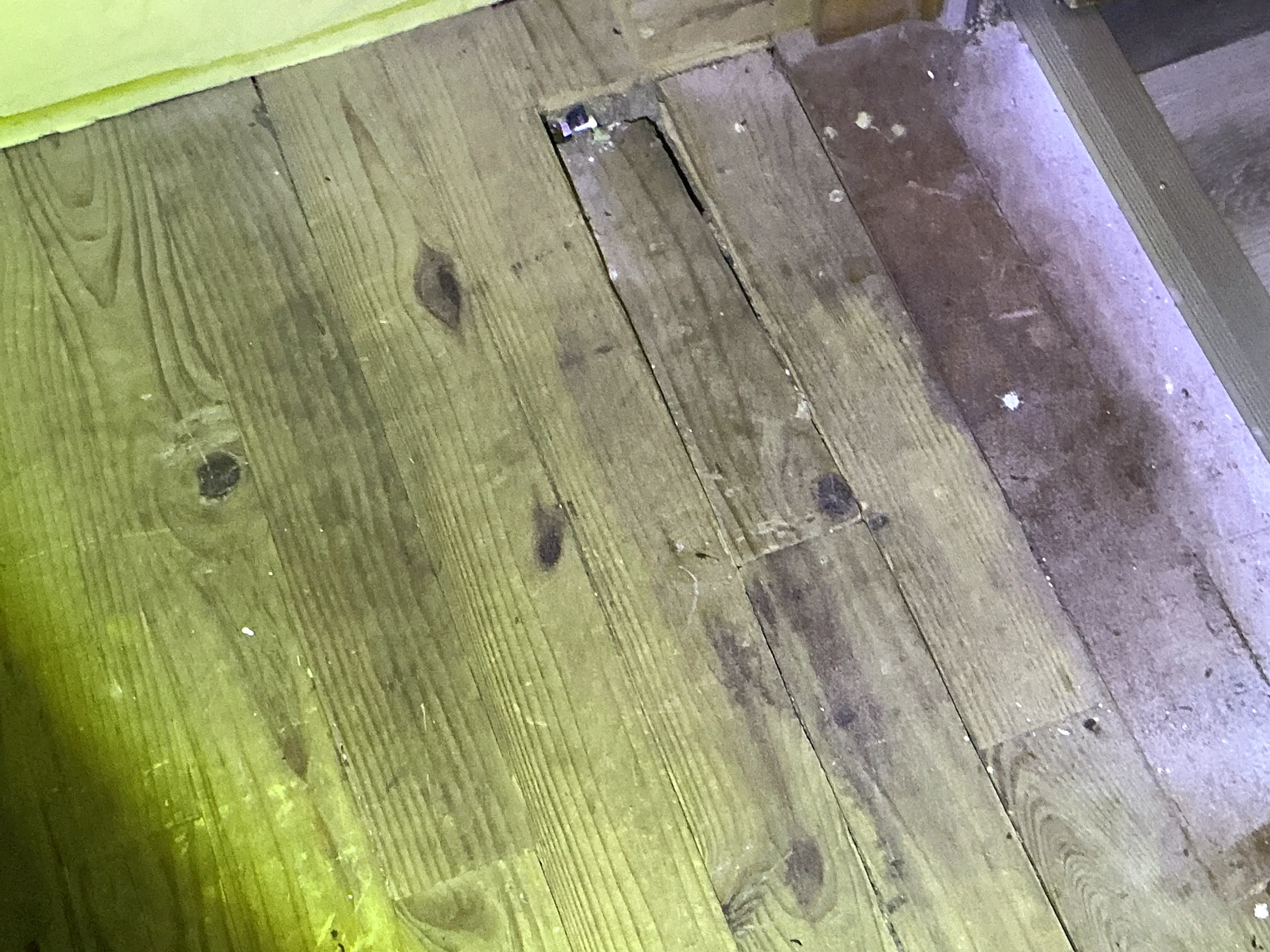 Damaged wood floorboards with gaps and cutouts needing repair 2026-08-25