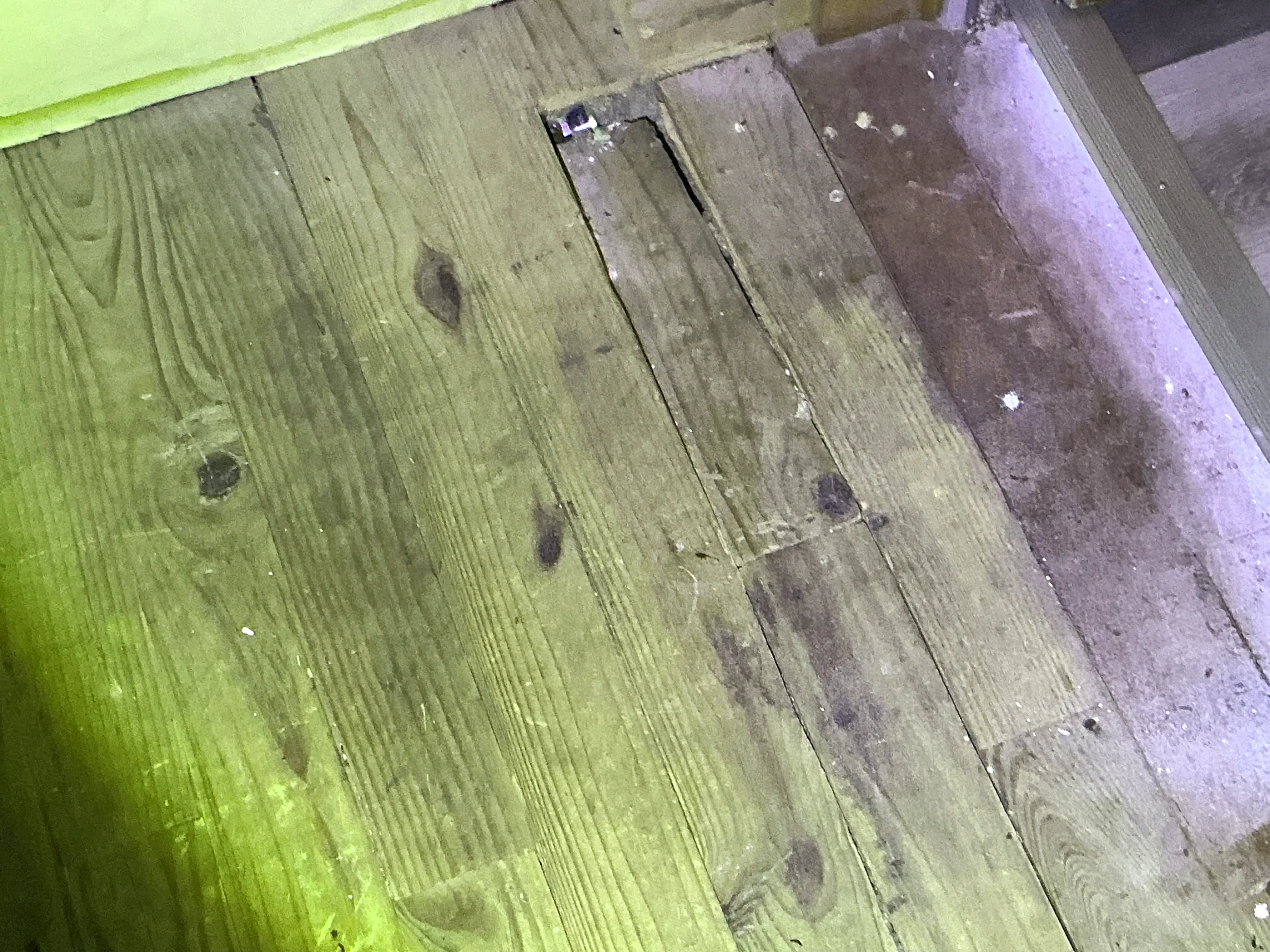 Damaged wood floorboards with gaps and cutouts needing repair 2026-08-03