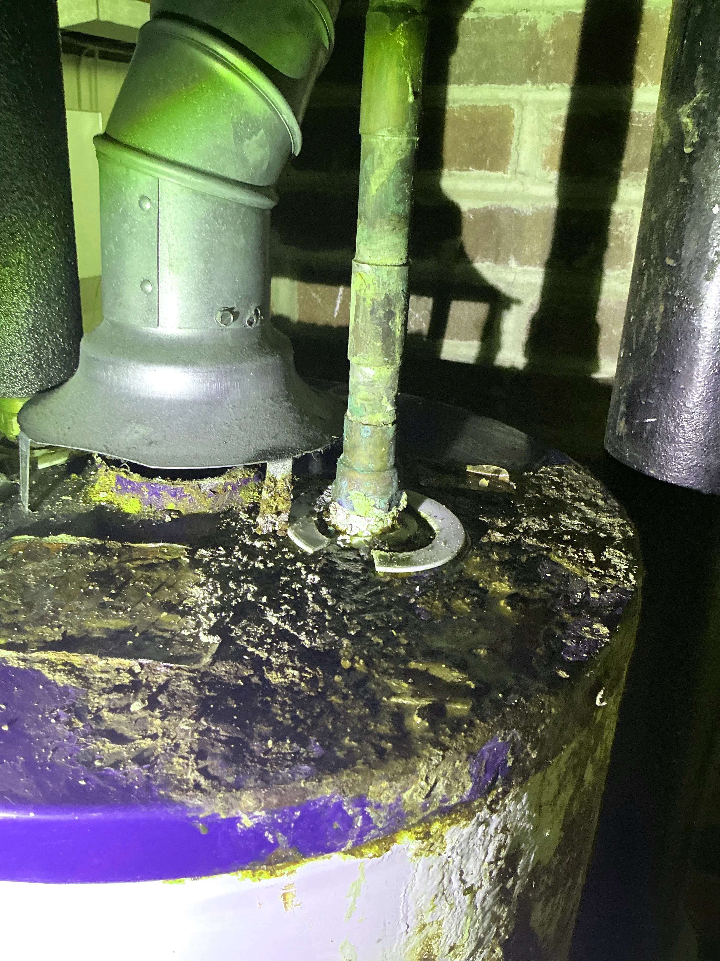 Corroded water heater plumbing connection with heavy rust and mineral deposits on top of the unit 2026-08-25