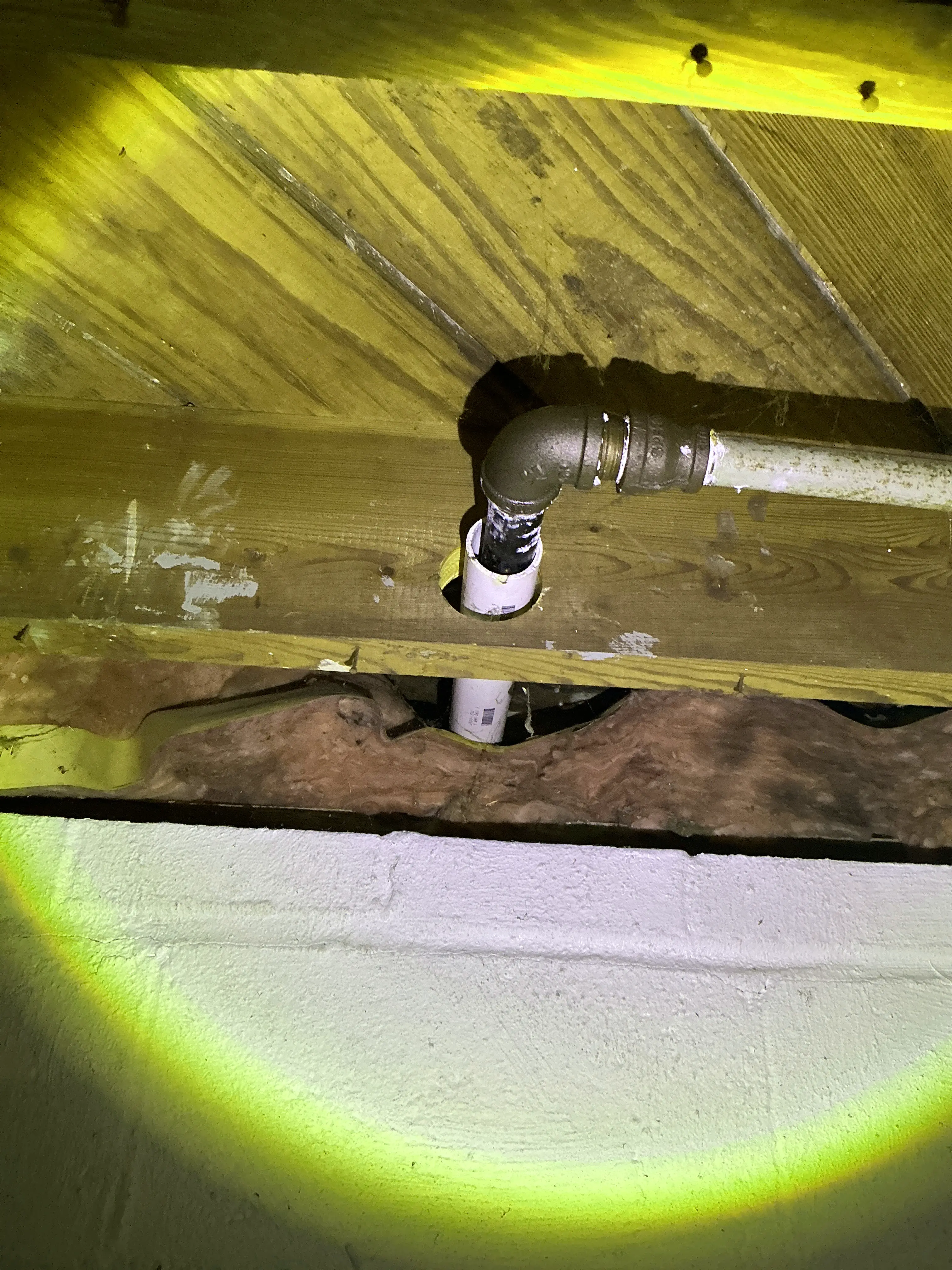 Metal pipe penetration through wooden framing near concrete block foundation wall 2026-08-08