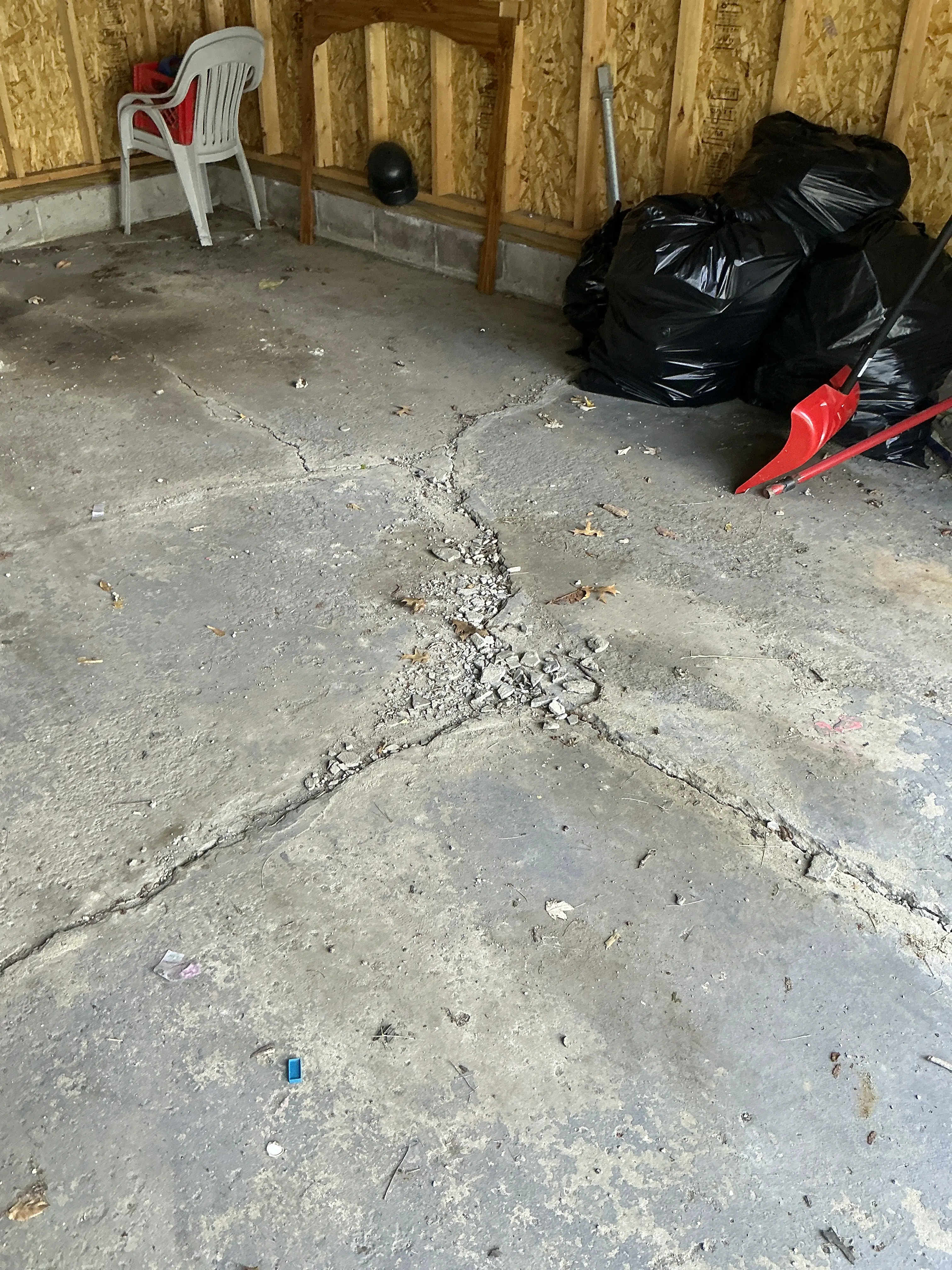 Cracked and crumbling concrete slab floor in garage 2026-07-04