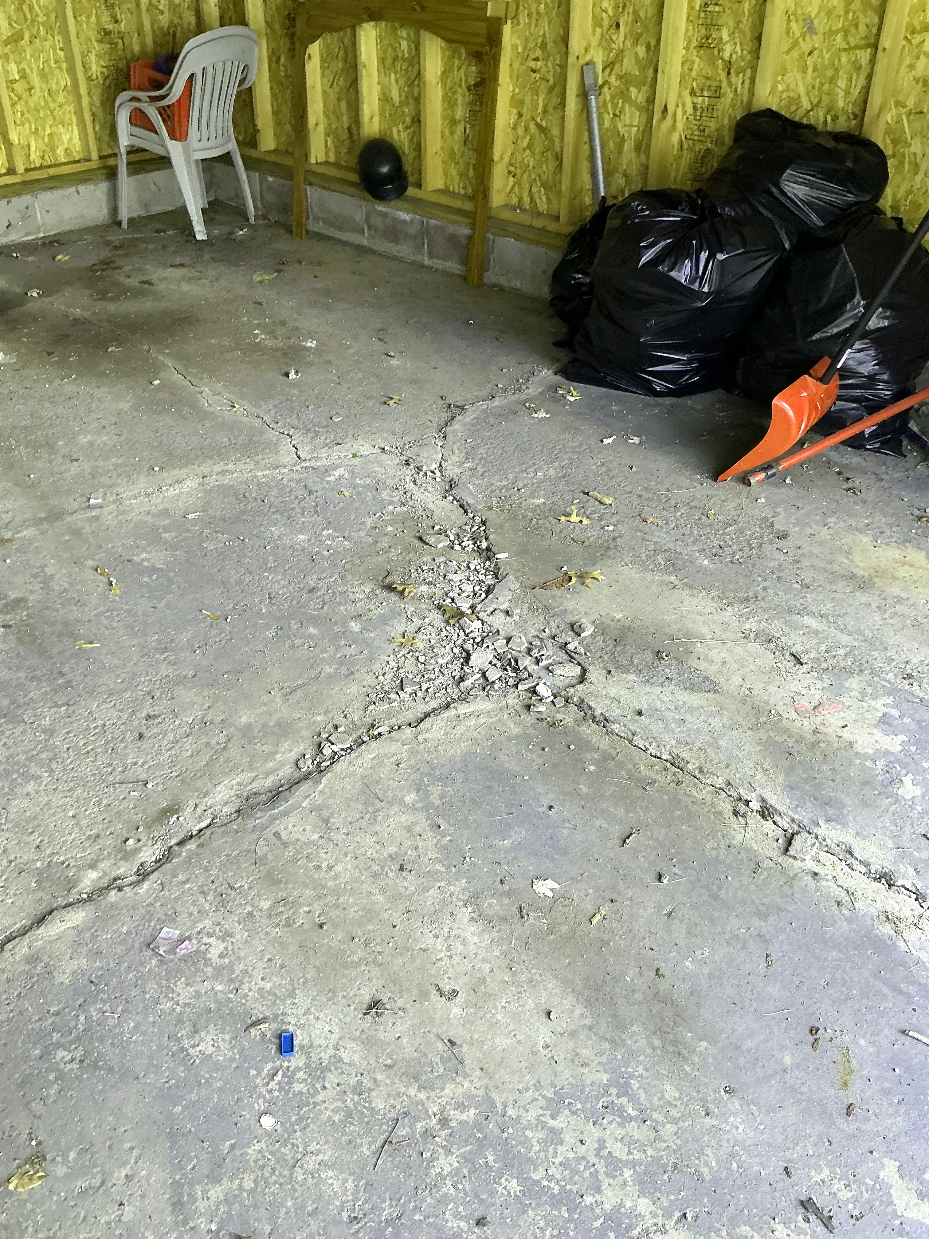Cracked and crumbling concrete slab floor in garage 2026-08-02