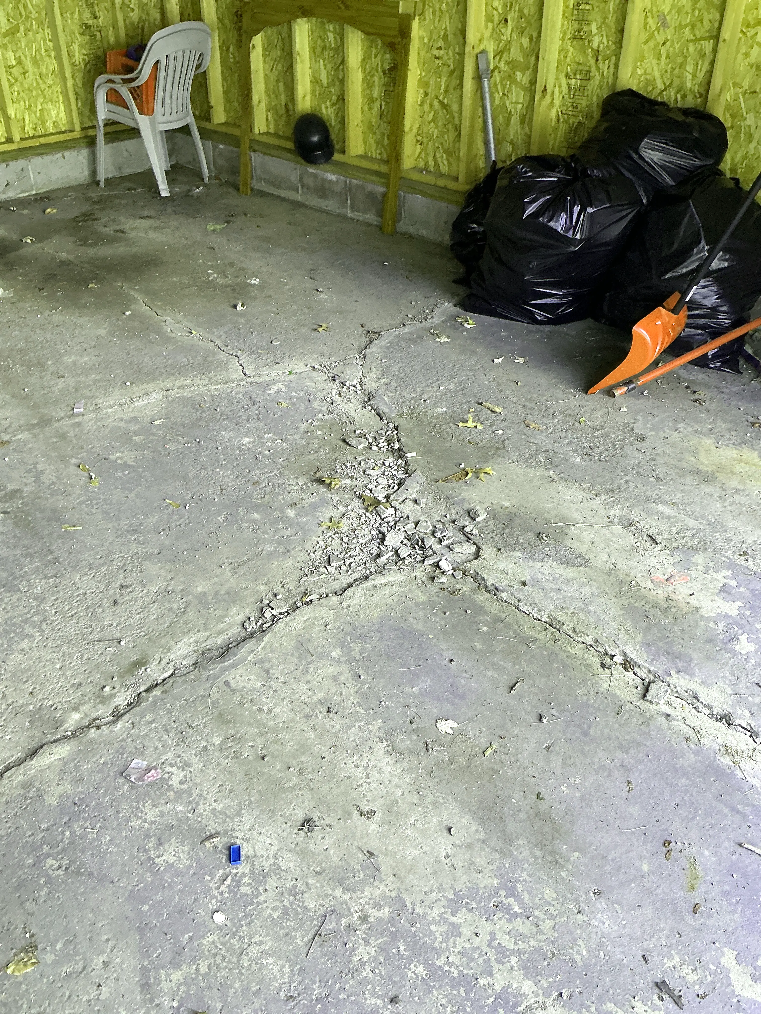 Cracked and crumbling concrete slab floor in garage 2026-08-10