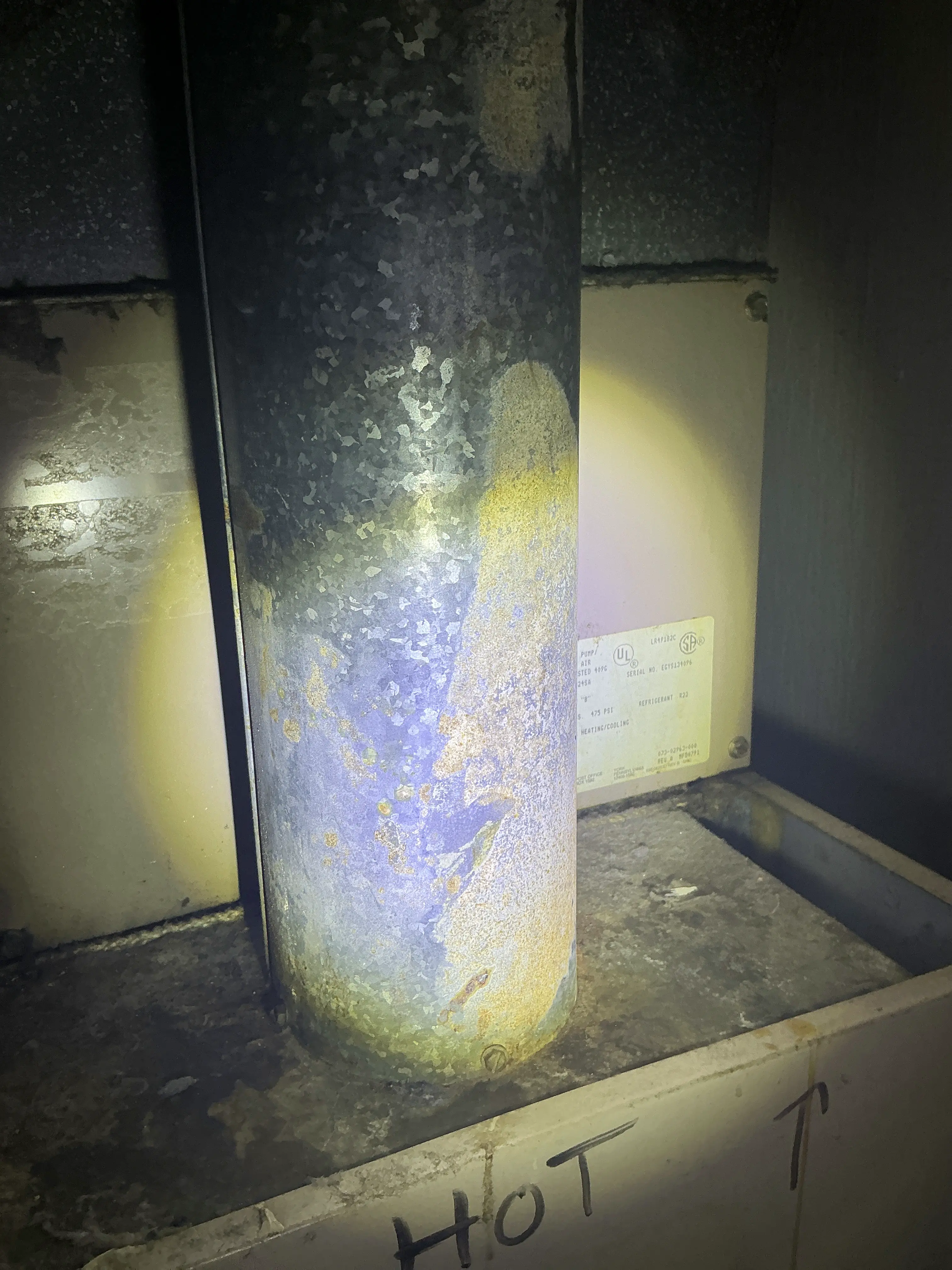 Corroded metal vent pipe in a home heating system showing surface rust. 2026-08-05
