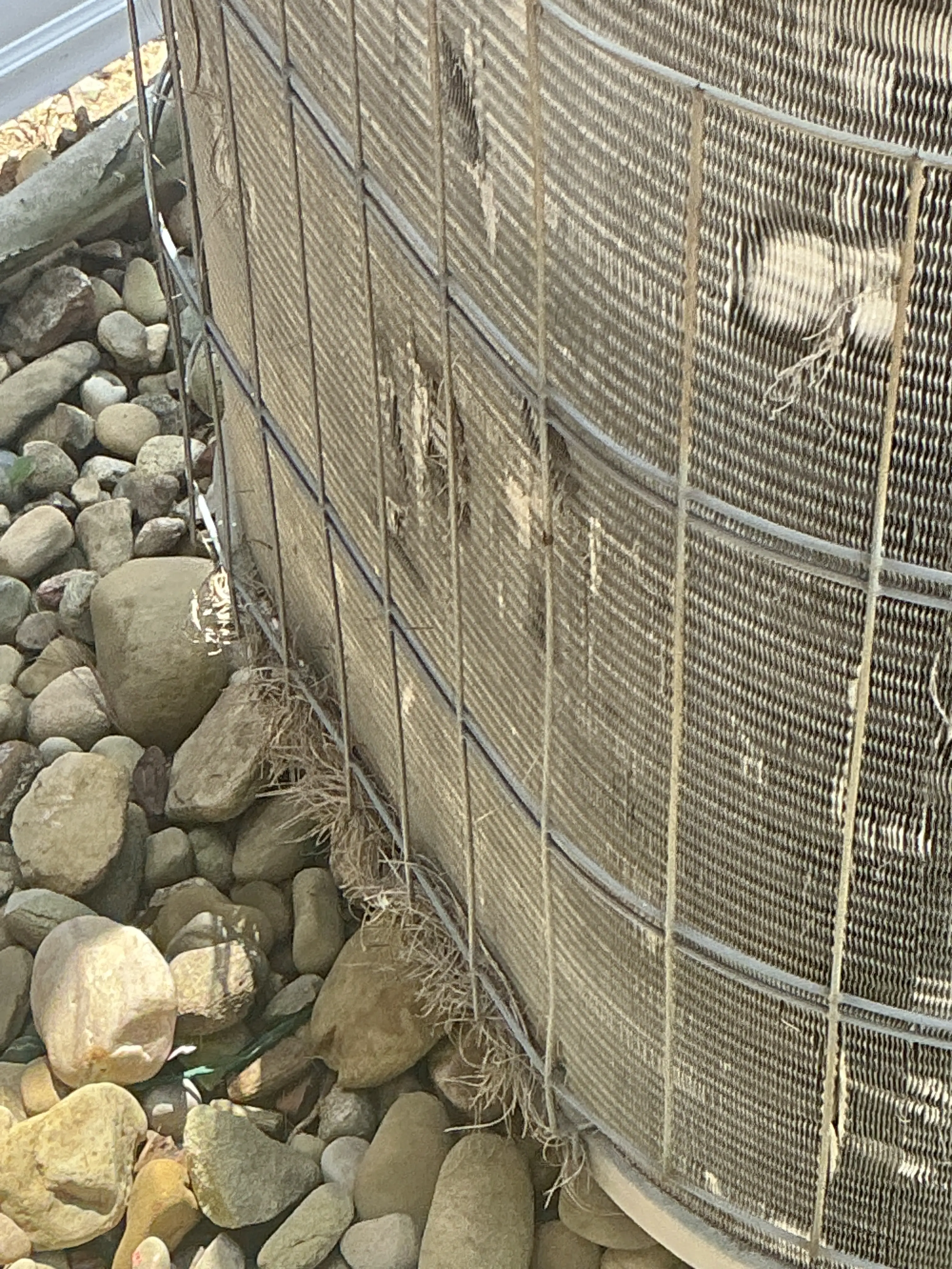 Damaged condenser coil fins on an outdoor air conditioner unit 2026-07-28
